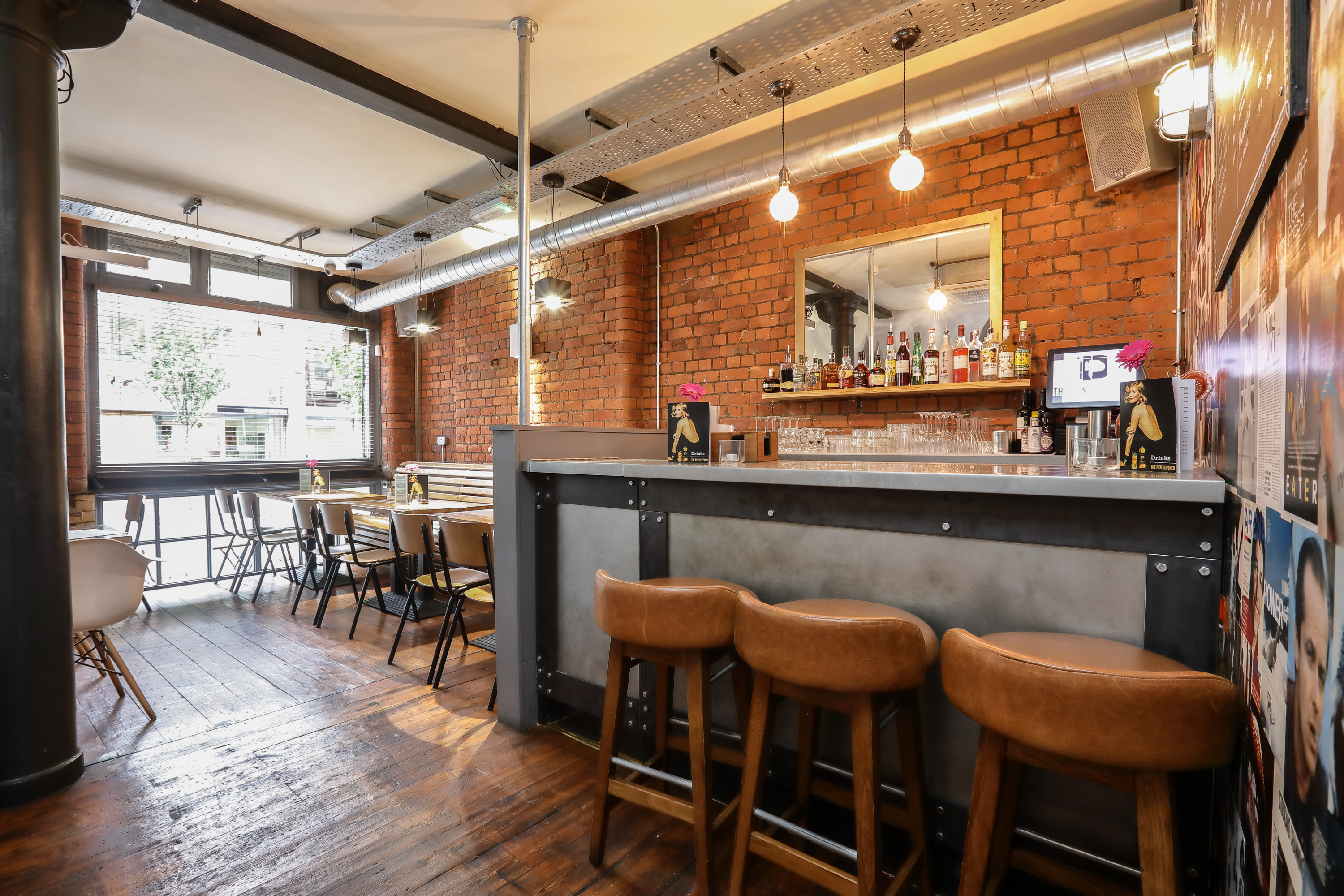 Stylish bar area with exposed brick, perfect for cocktail receptions and networking events.