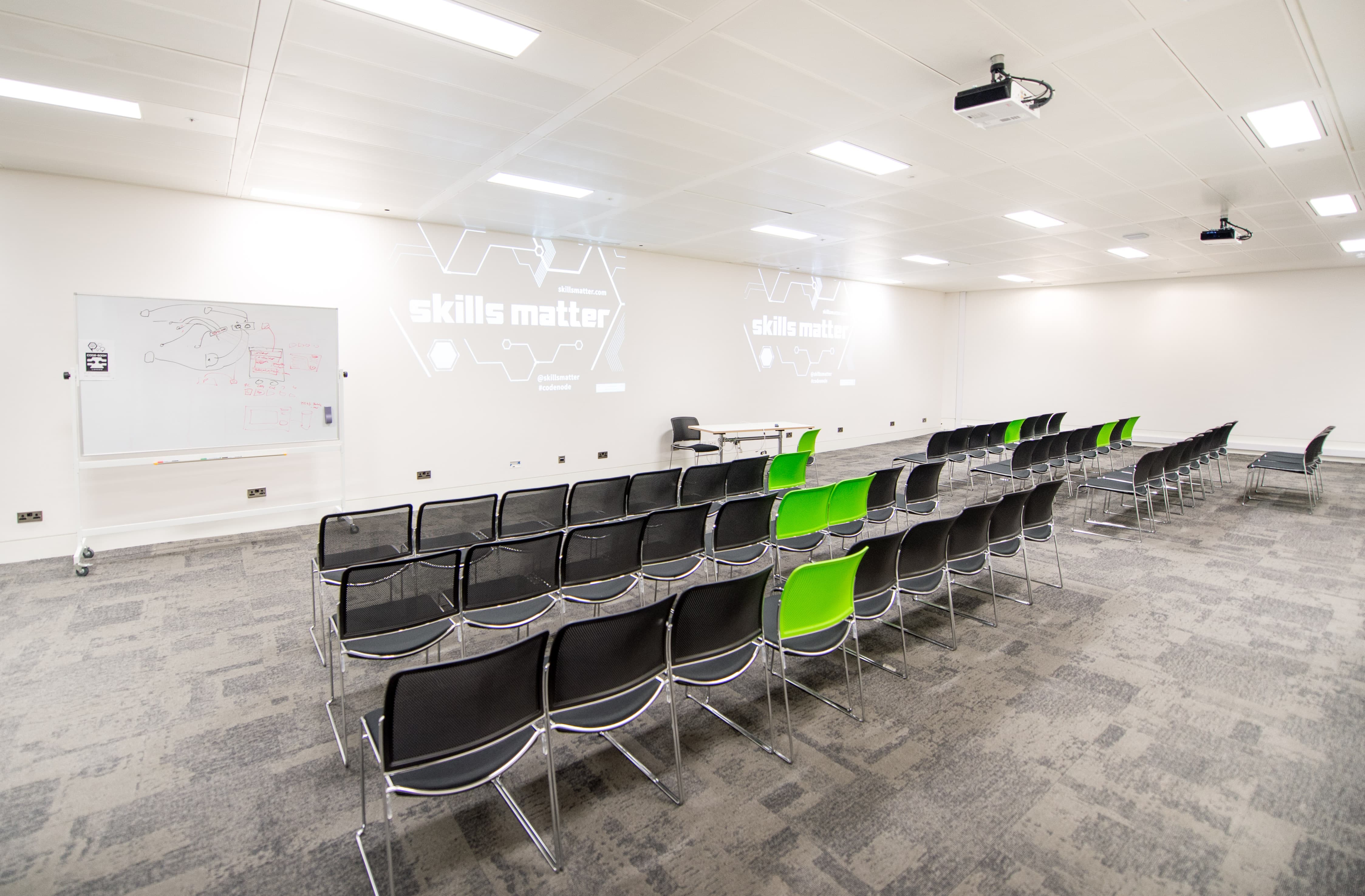 Versatile meeting space at CodeNode with green accents for hybrid events and workshops.