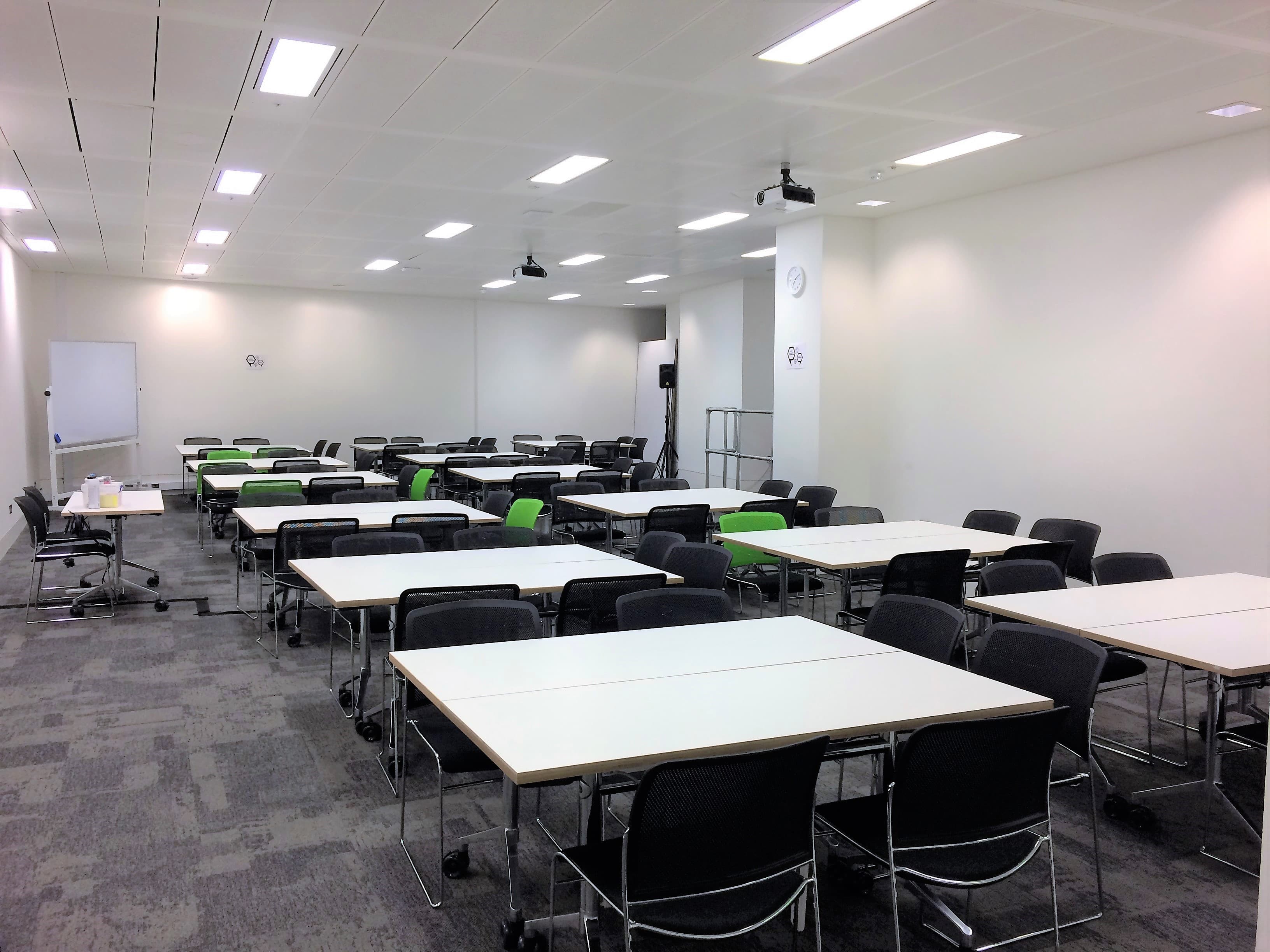 Versatile meeting space at CodeNode with flexible tables for workshops and breakout sessions.