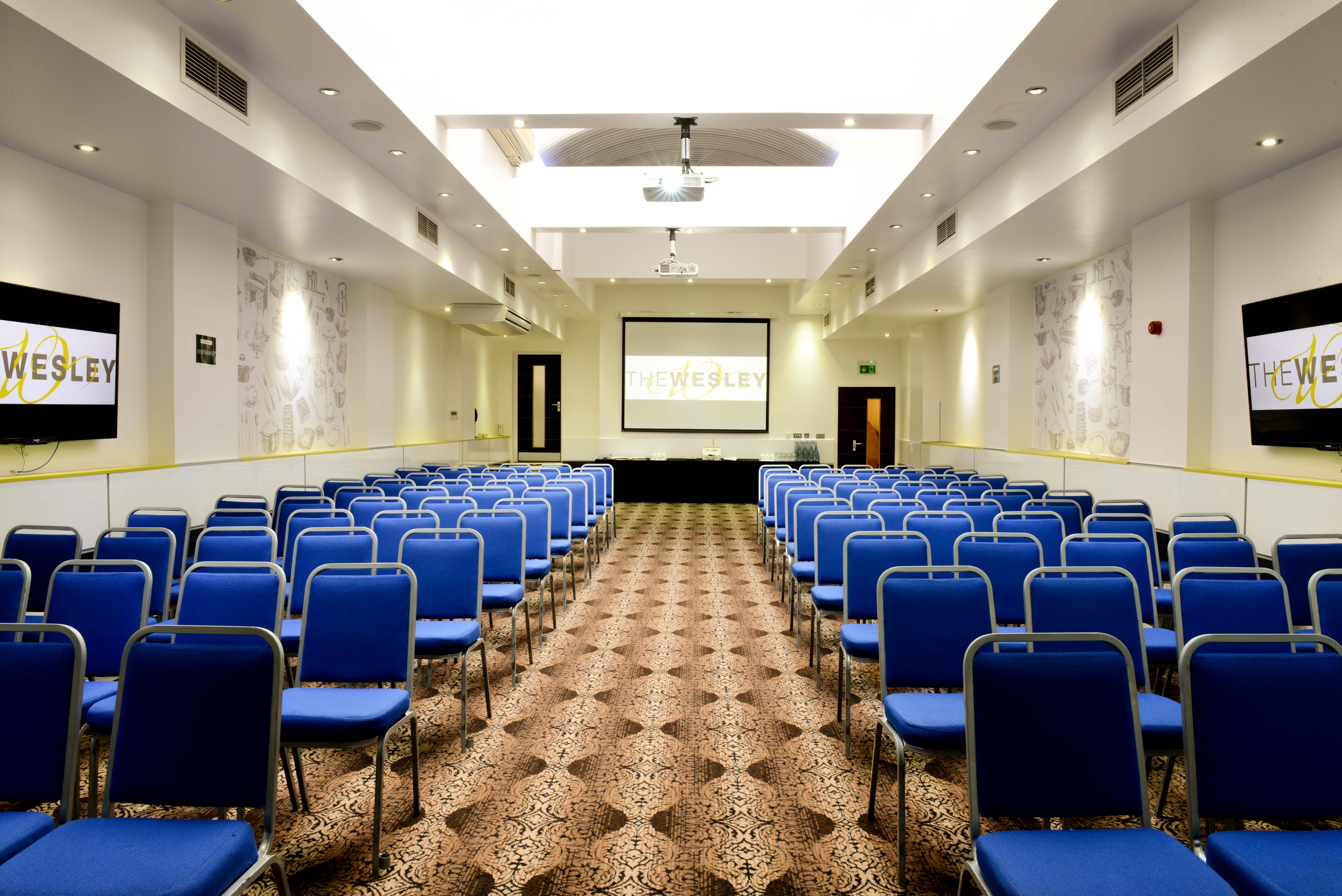 Porter Hall conference room with blue chairs, ideal for presentations and workshops.