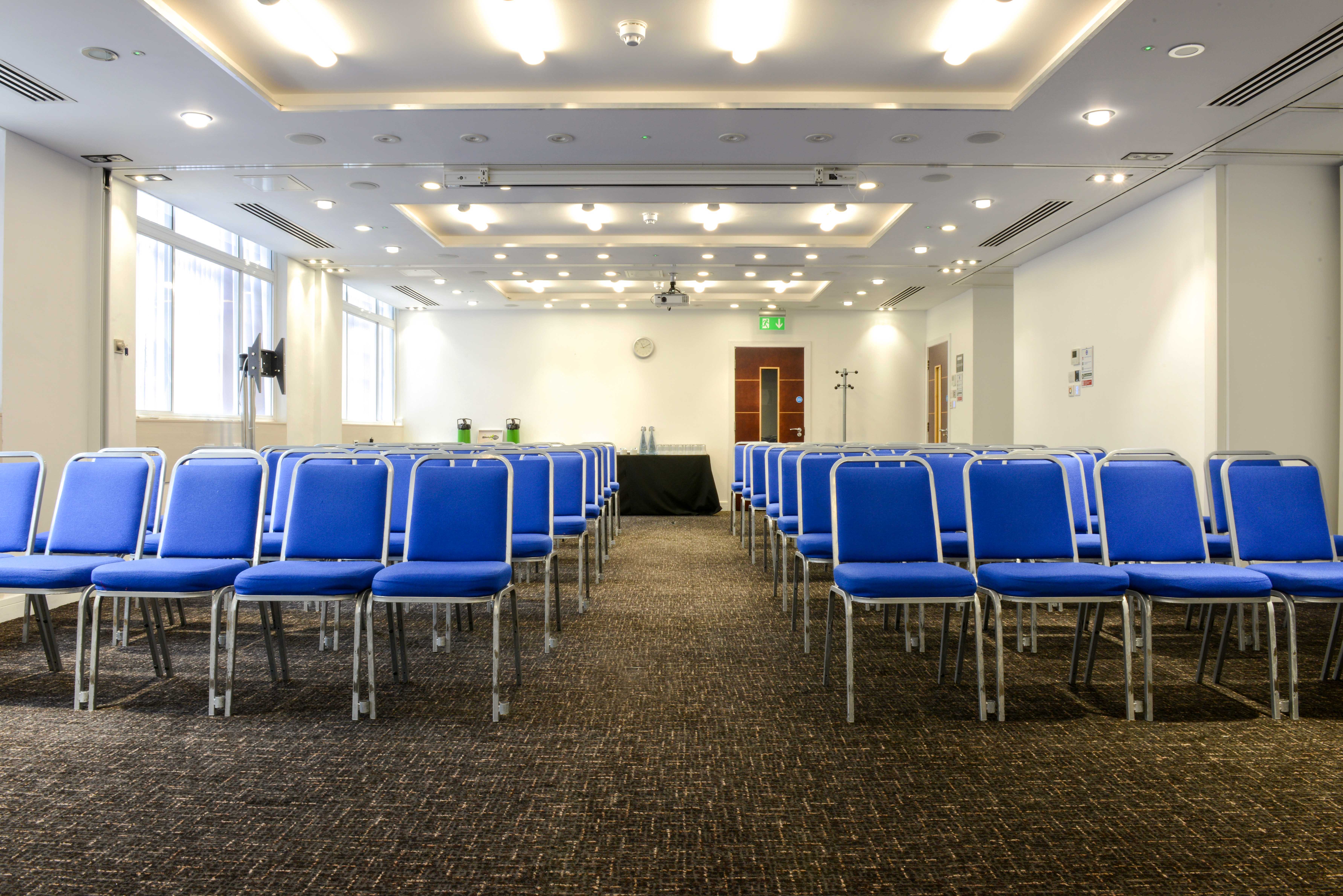 Camden Suite meeting space with blue chairs, ideal for conferences and presentations.
