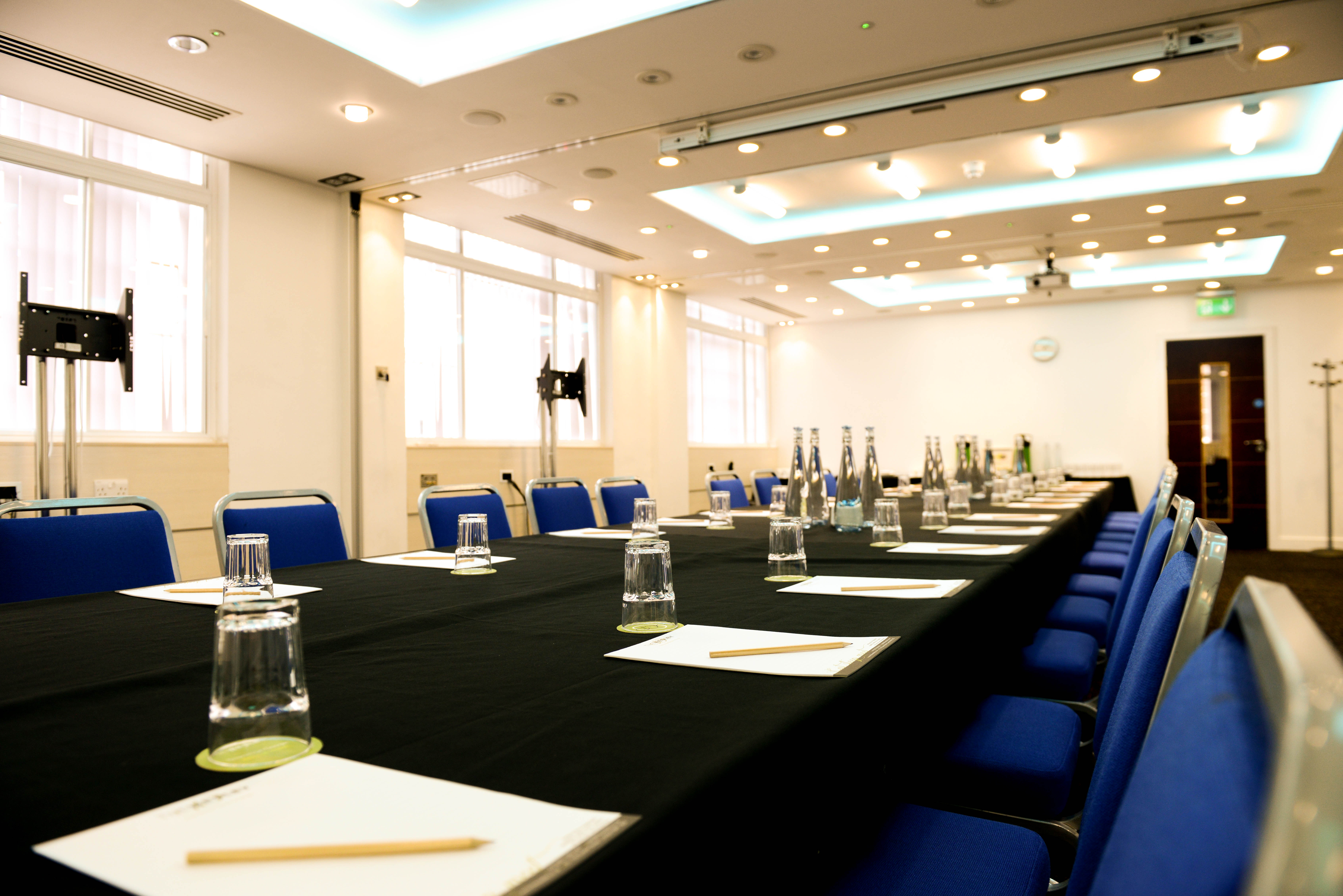 Camden Suite meeting room with blue chairs, ready for professional events and conferences.