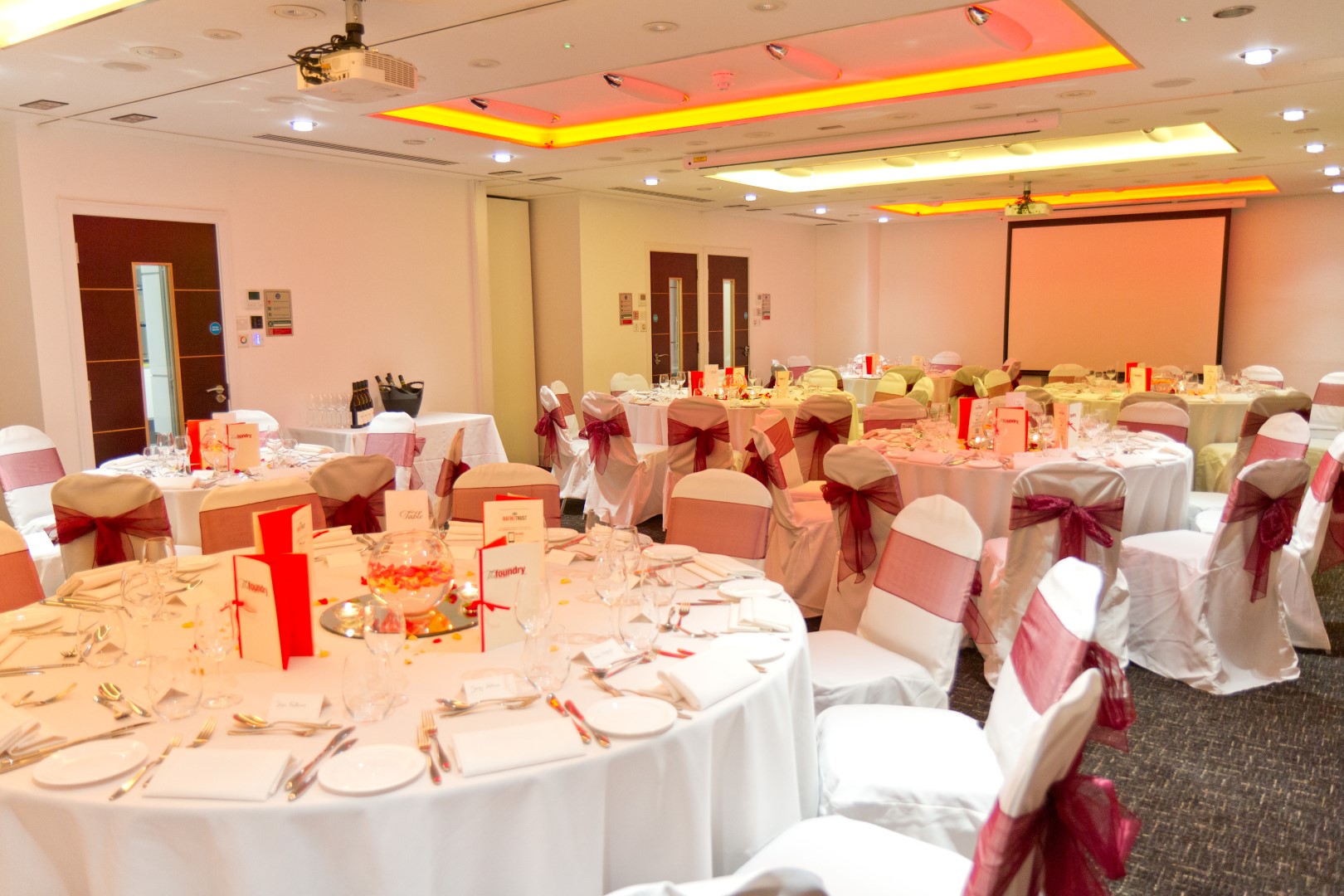 Camden Suite at The Wesley Euston Hotel, elegant event space with round tables for celebrations.