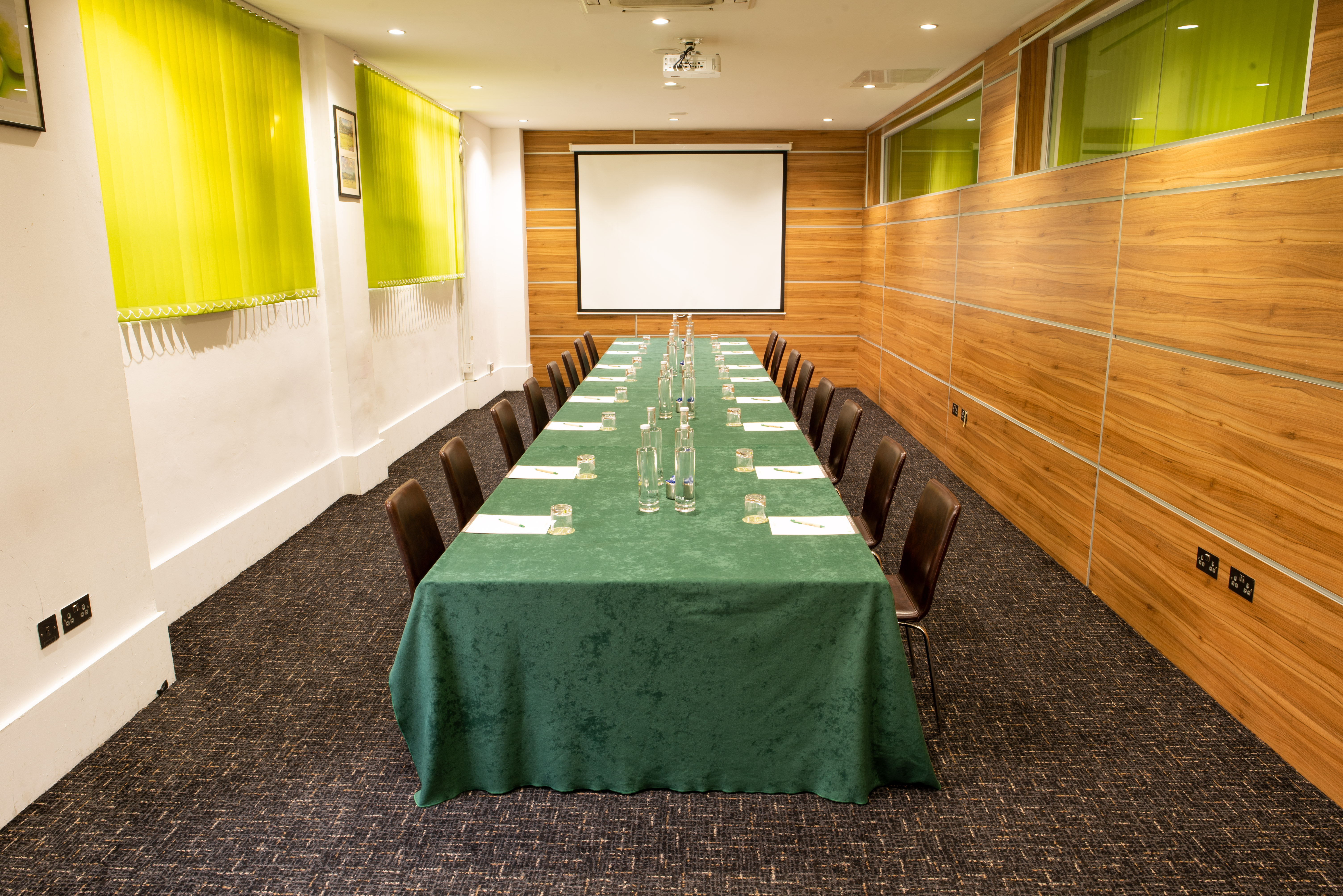 Meeting room at Wesley Euston Hotel, featuring elegant green tablecloth for conferences.