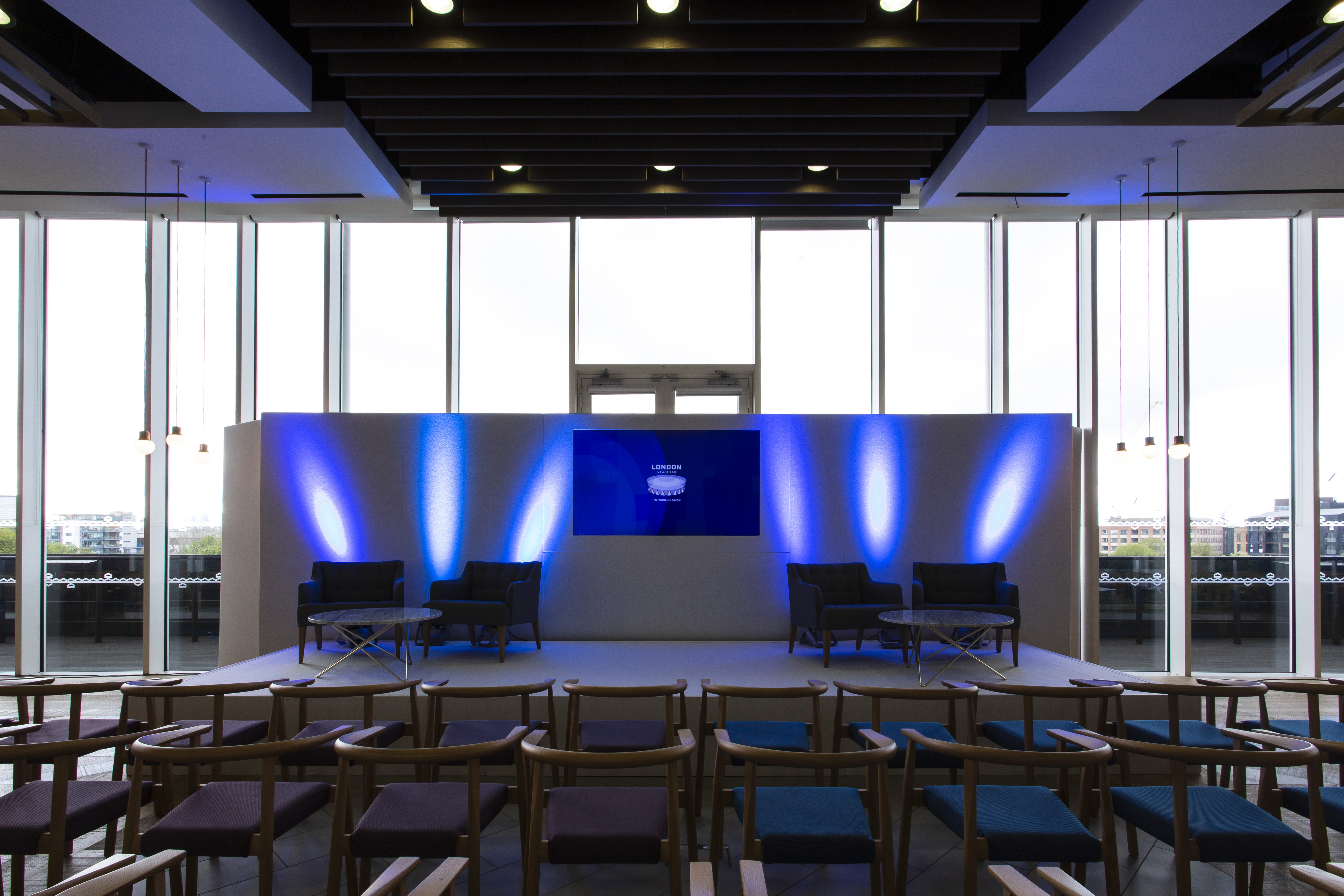 Event space at London Stadium with sleek stage, ideal for conferences and panel discussions.