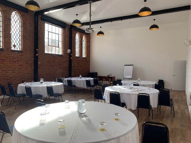 Fazeley Studios event space with round tables, ideal for meetings and workshops.