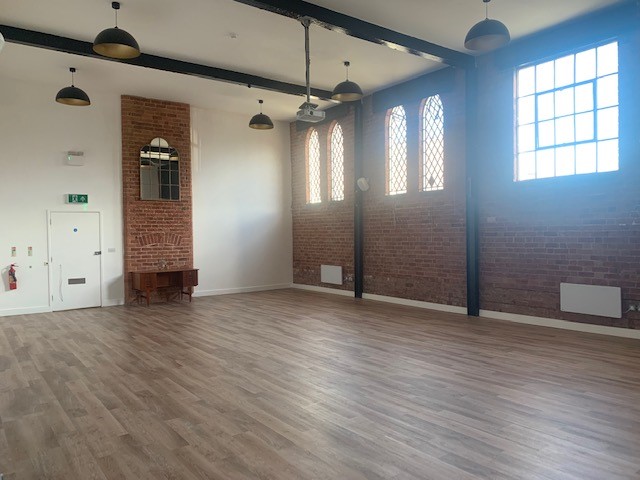 Fazeley Studios event venue with exposed brick walls and natural light for gatherings.