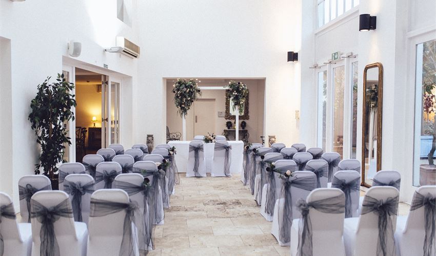 Elegant Fazeley Studios event space with draped chairs, ideal for weddings and gatherings.
