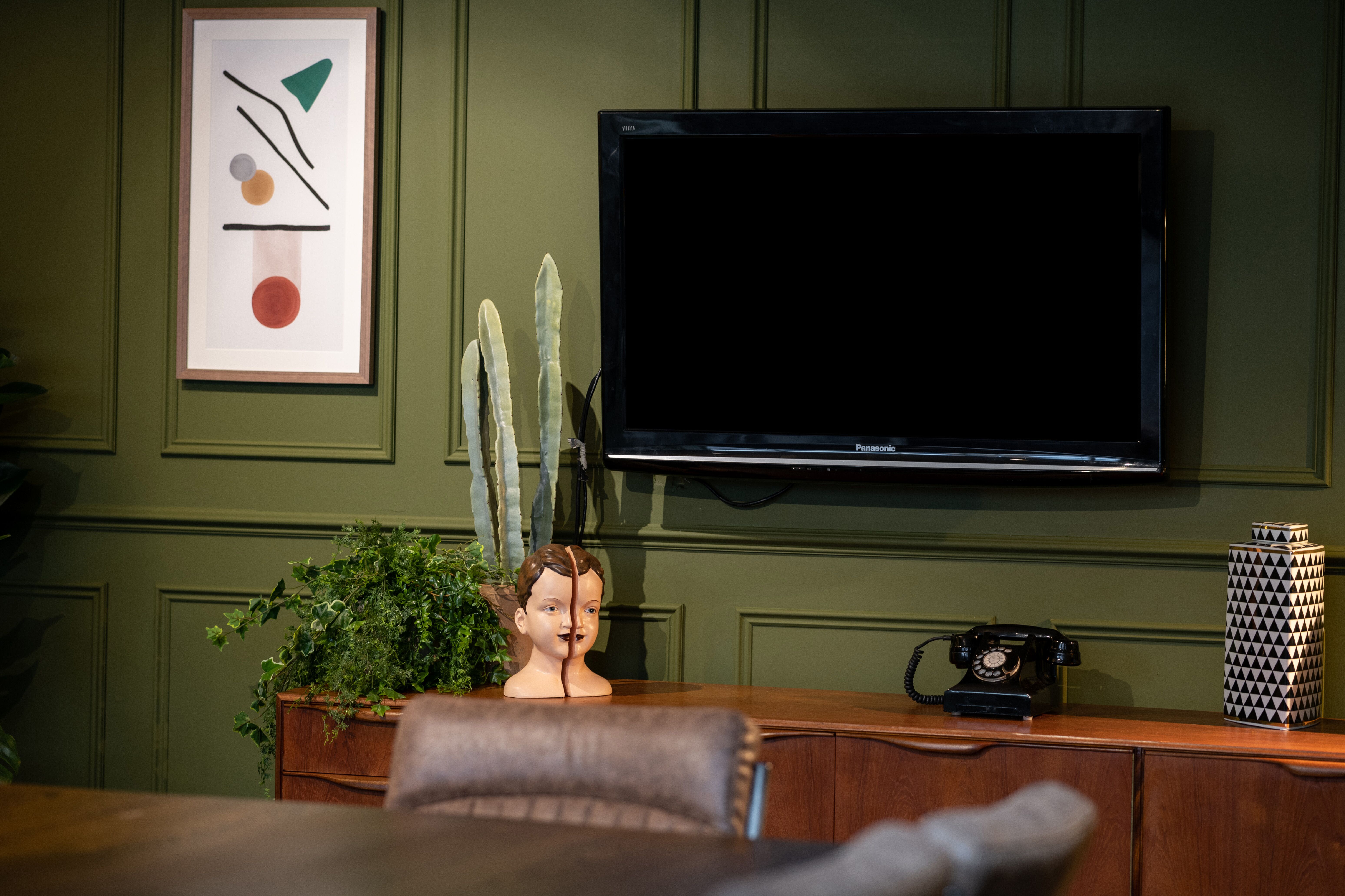Stylish meeting room with green walls at The Social Boardroom, Fazeley Studios.