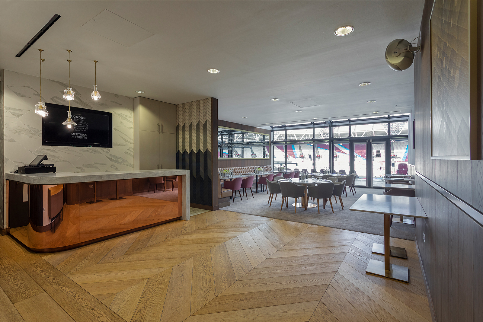 Modern event space in London Stadium with elegant reception and natural light for meetings.