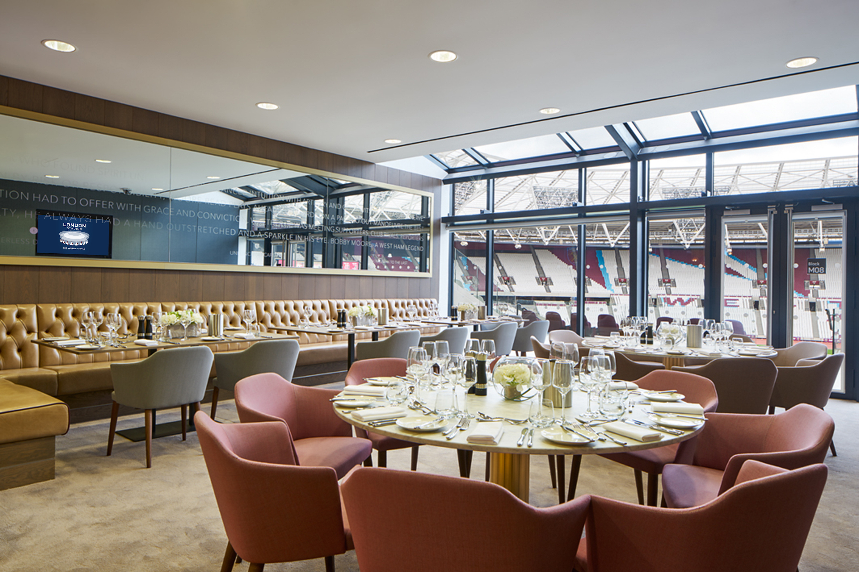 Elegant event space in London Stadium with fine dining setup for corporate gatherings.