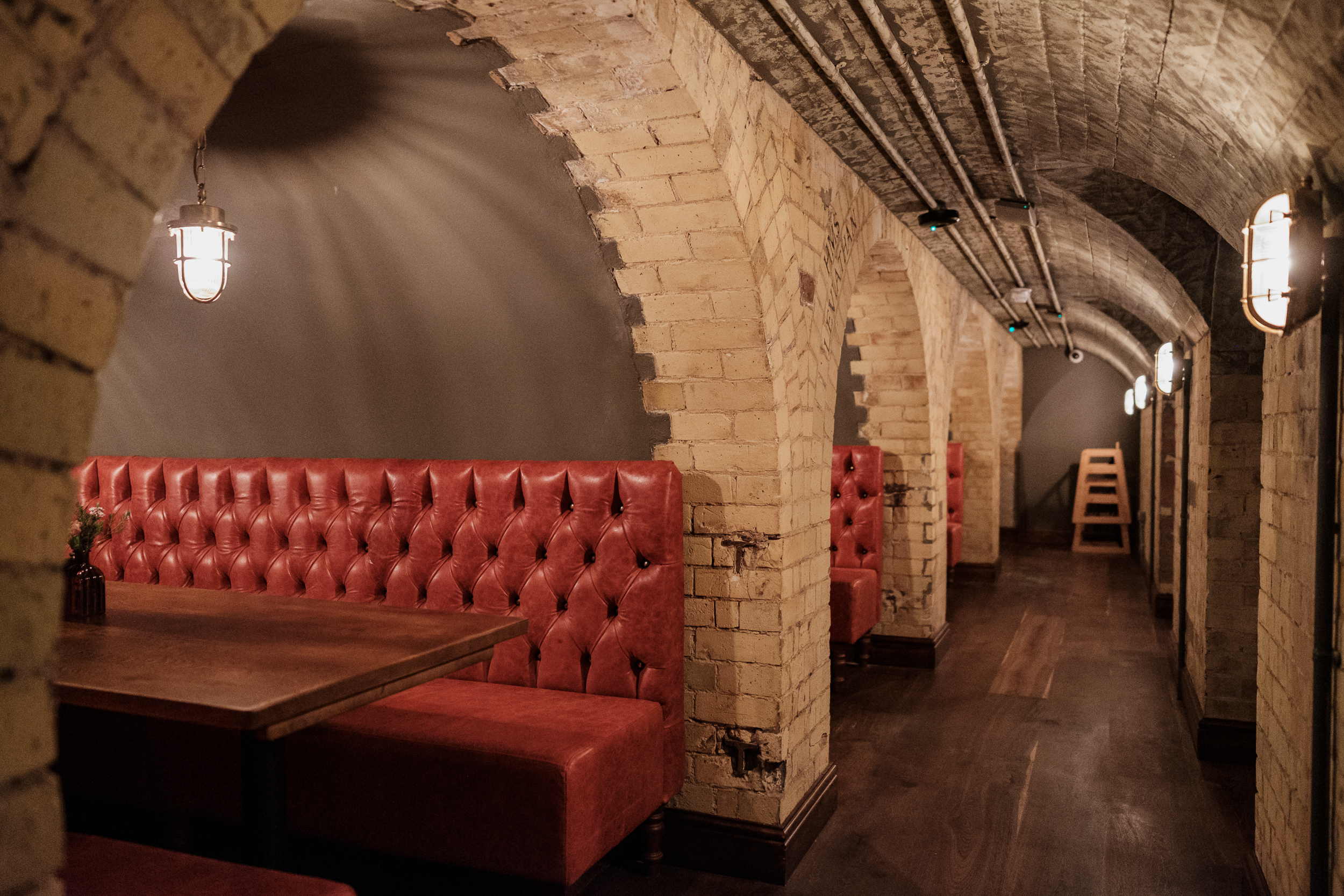 Stylish underground venue with brick arches, ideal for intimate gatherings and events.