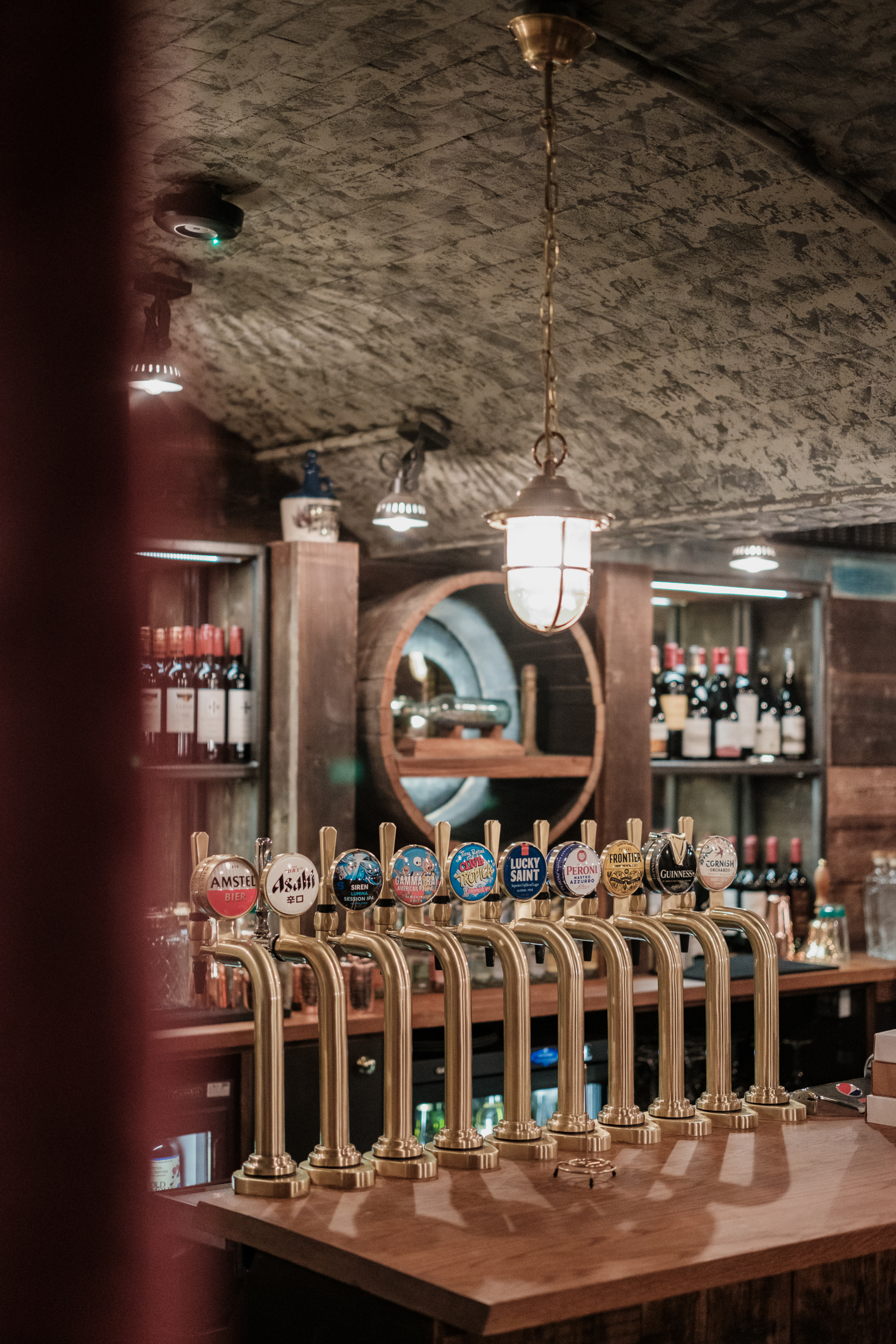 Lower Deck bar with beer taps and warm lighting for networking events and social gatherings.