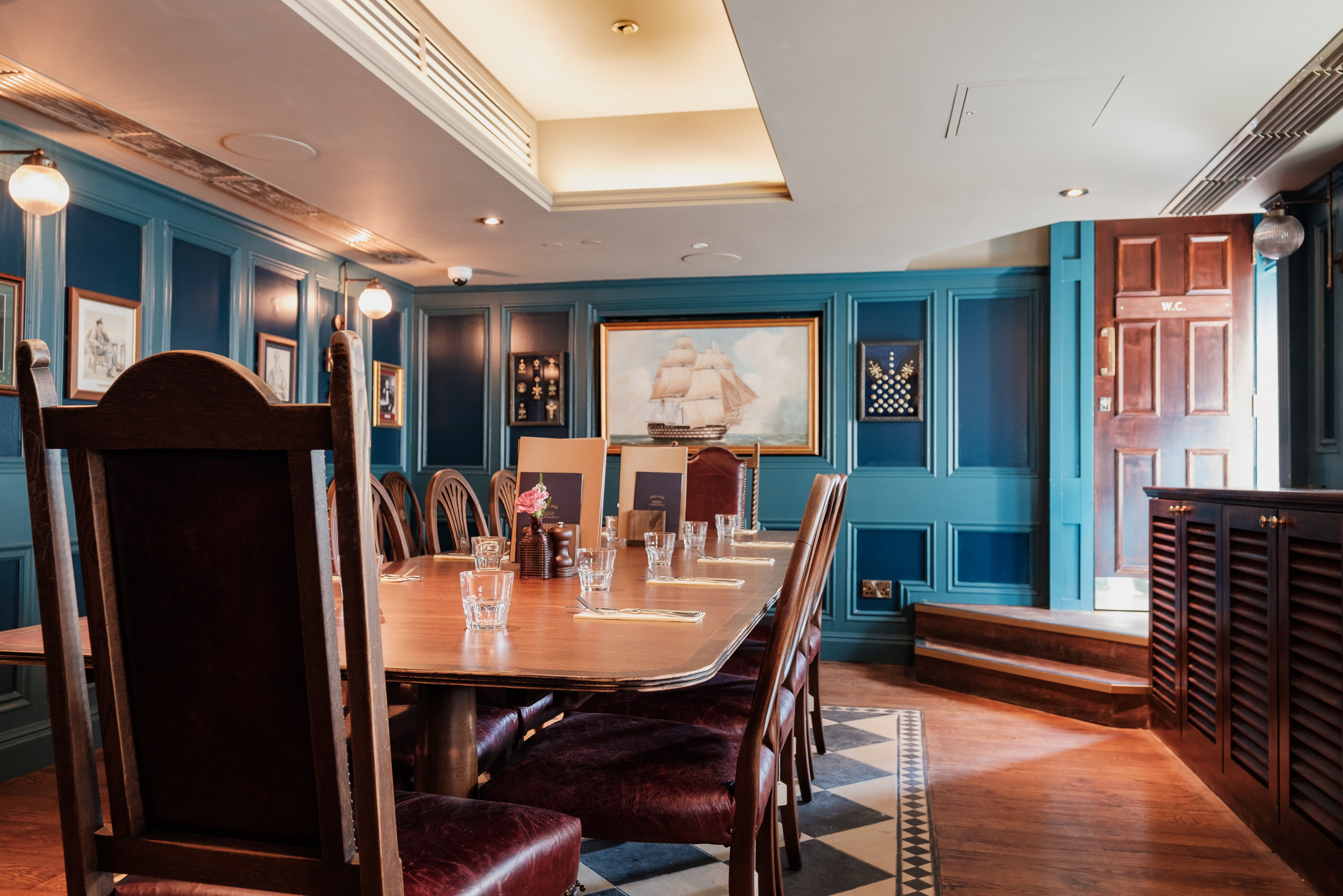 Admiral's Cabin meeting room with wooden table, ideal for executive meetings and gatherings.