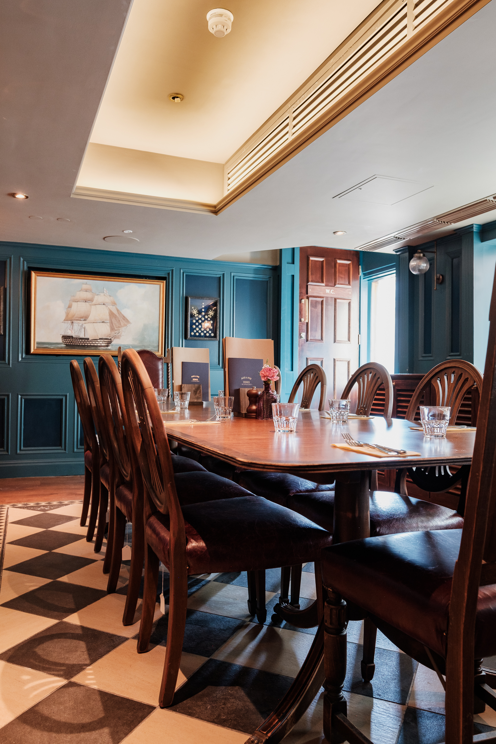 Admiral's Cabin meeting room with wooden table, ideal for corporate events and gatherings.