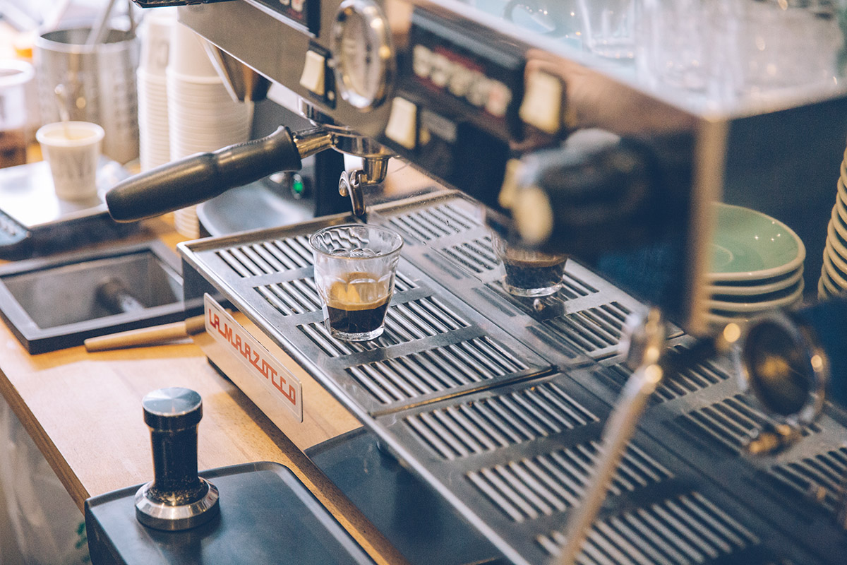 Sleek espresso machine brewing coffee for engaging event networking.