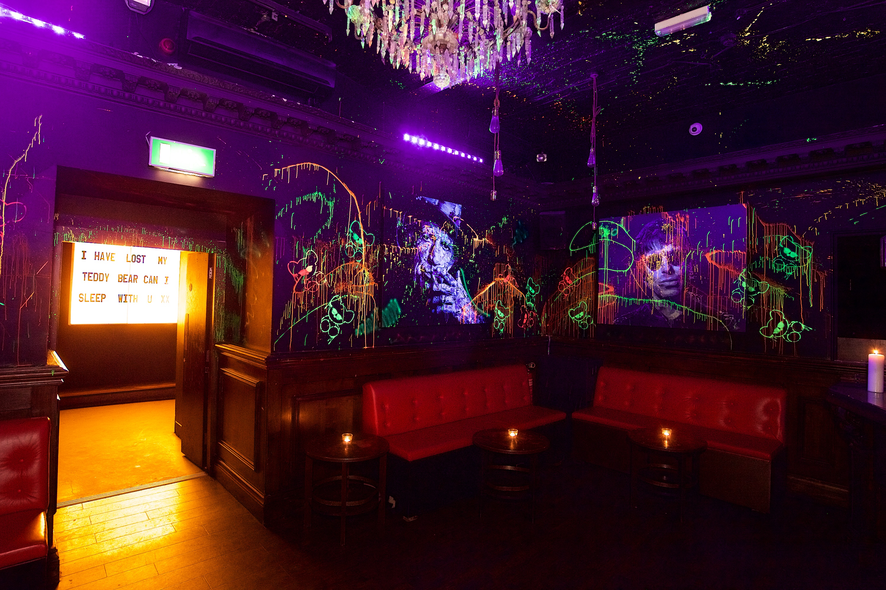 Neon-lit toy room with graffiti backdrop for creative gatherings and themed parties.