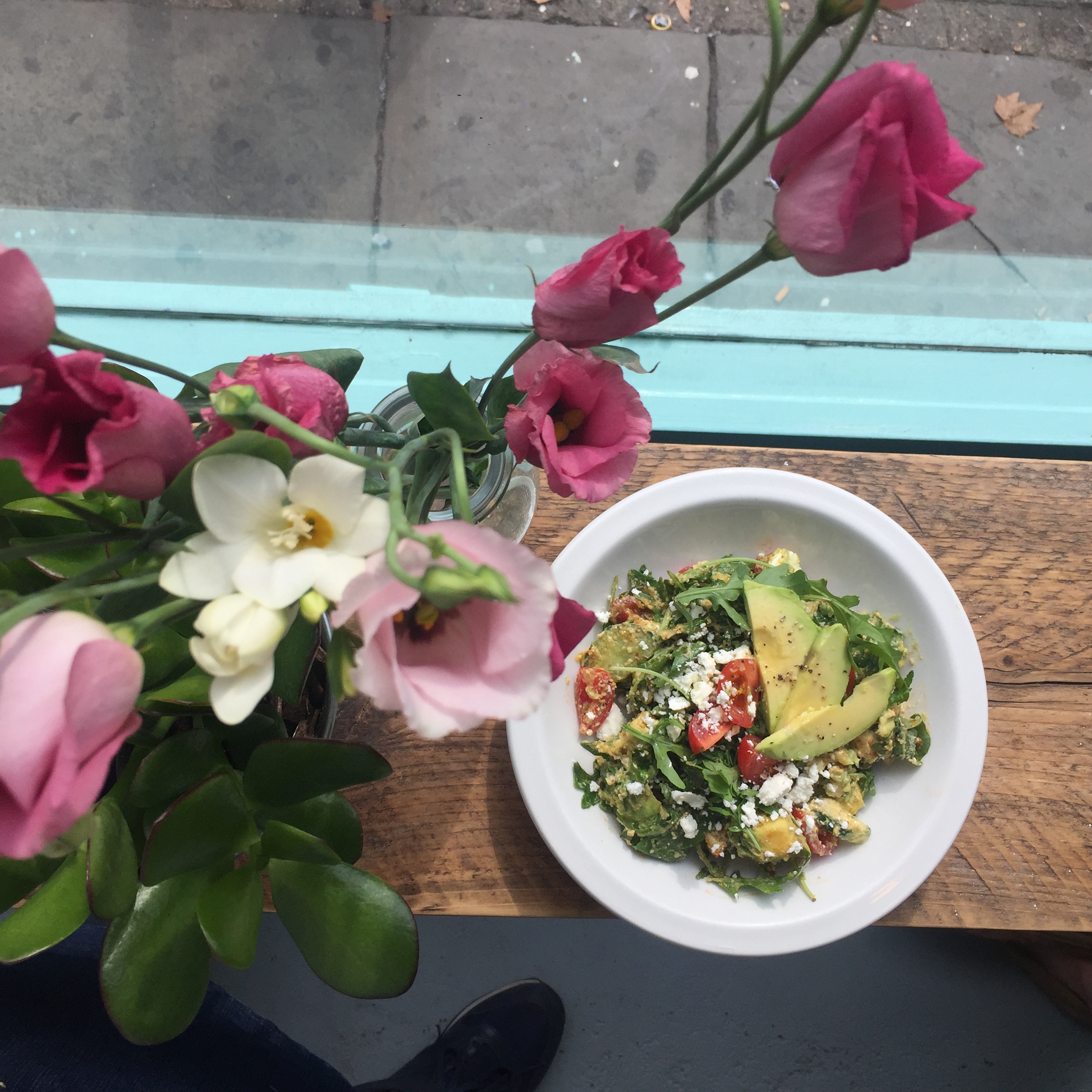 Elegant salad and fresh flowers at CAYA Event Space for health-focused catering options.