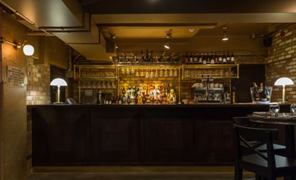 Stylish bar with rustic decor, perfect for intimate gatherings and networking events.