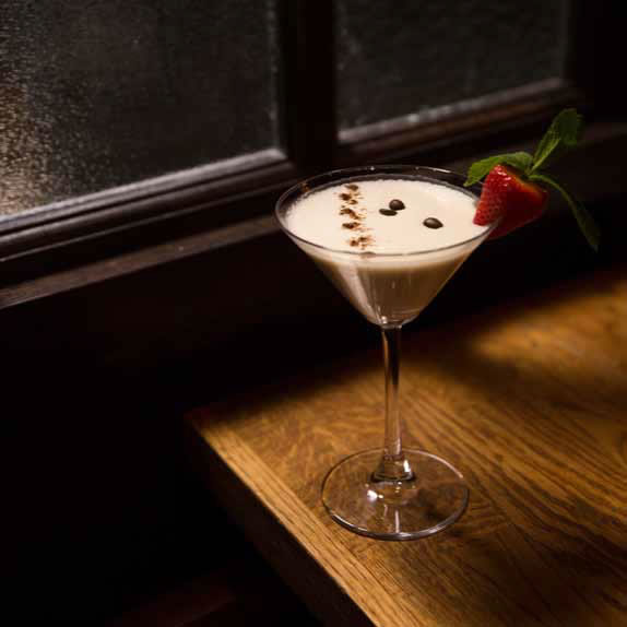 Elegant cocktail with strawberry garnish for upscale events and receptions.