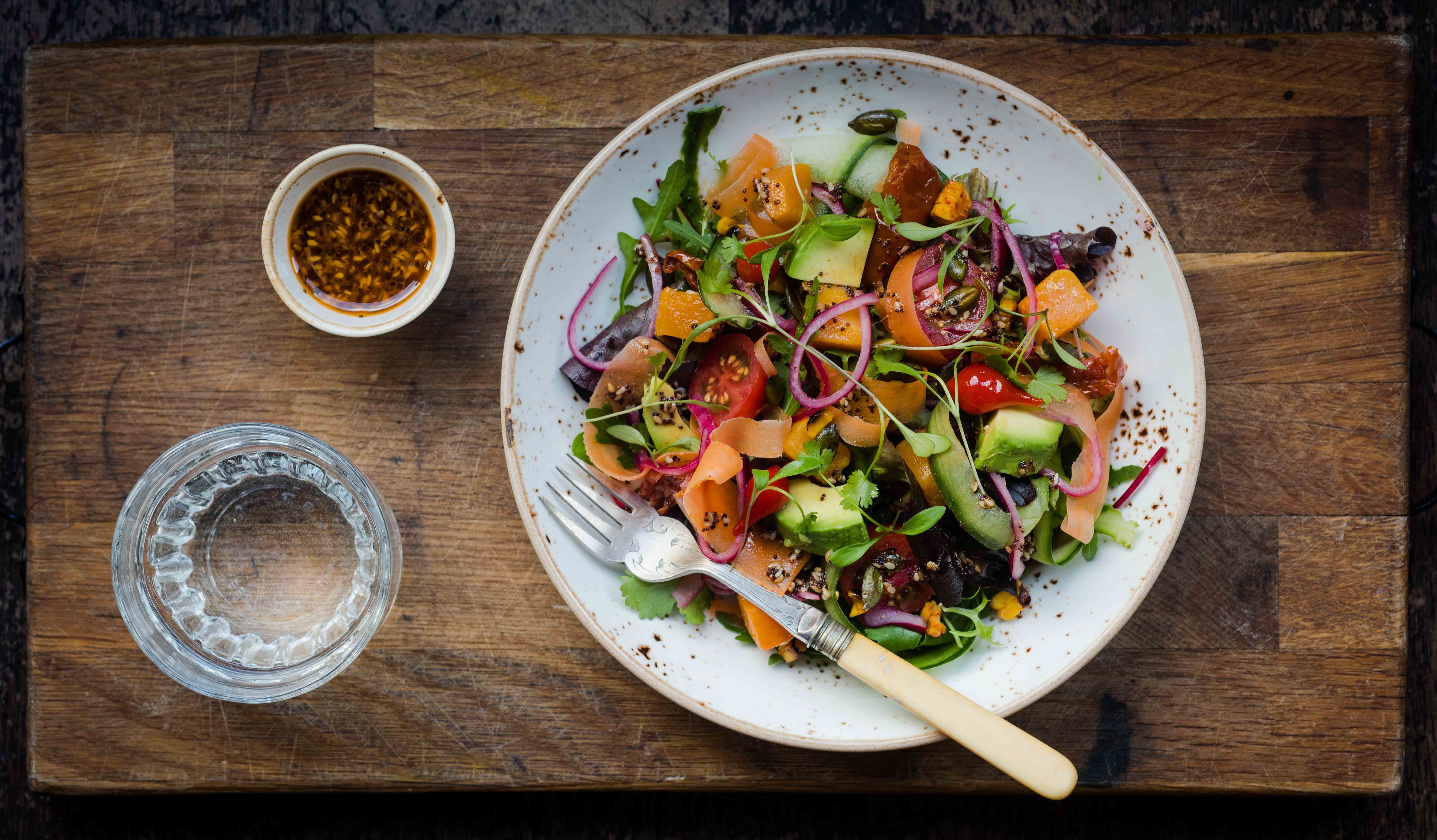 Vibrant salad on rustic wood, perfect for event catering in Las Iguanas Edinburgh.