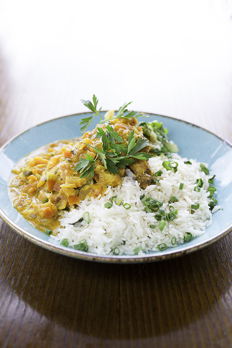 "Plated chicken dish with rice at Las Iguanas Edinburgh for events and catering."