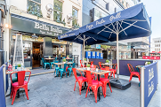 Vibrant outdoor dining area at Bella Italia, perfect for casual meetings and networking events.