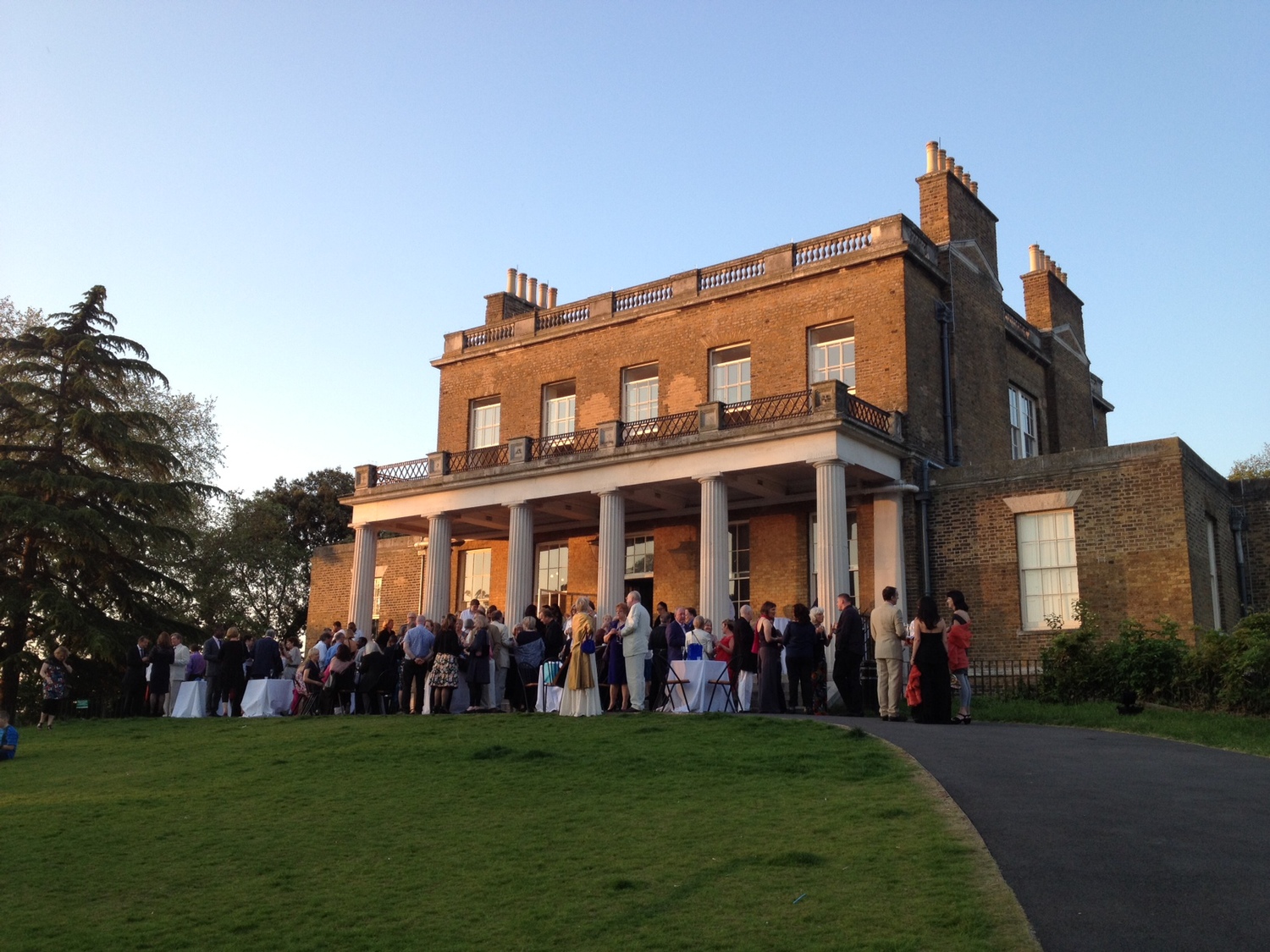Elegant outdoor event at Clissold House with guests mingling on a scenic terrace.