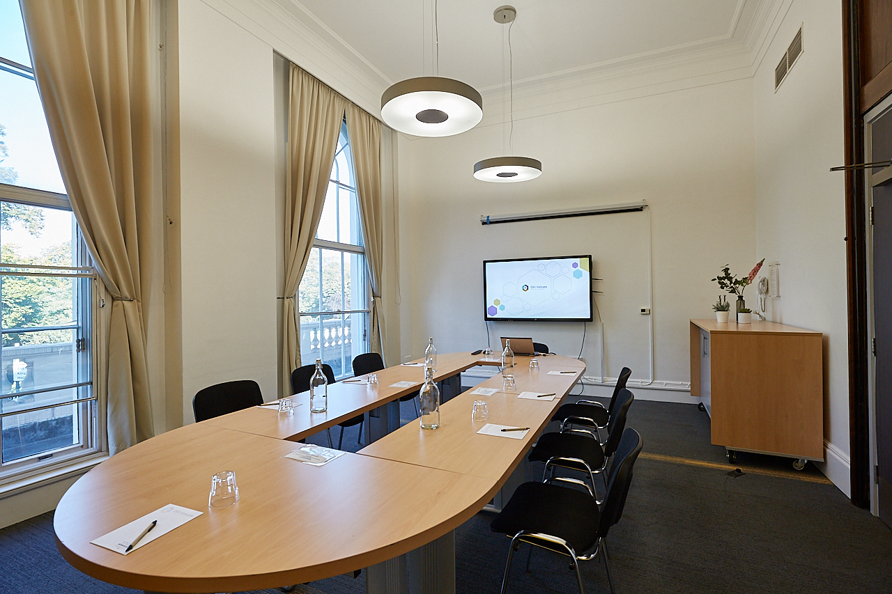 Boardroom at ISH Venues with oval table, ideal for professional meetings and events.