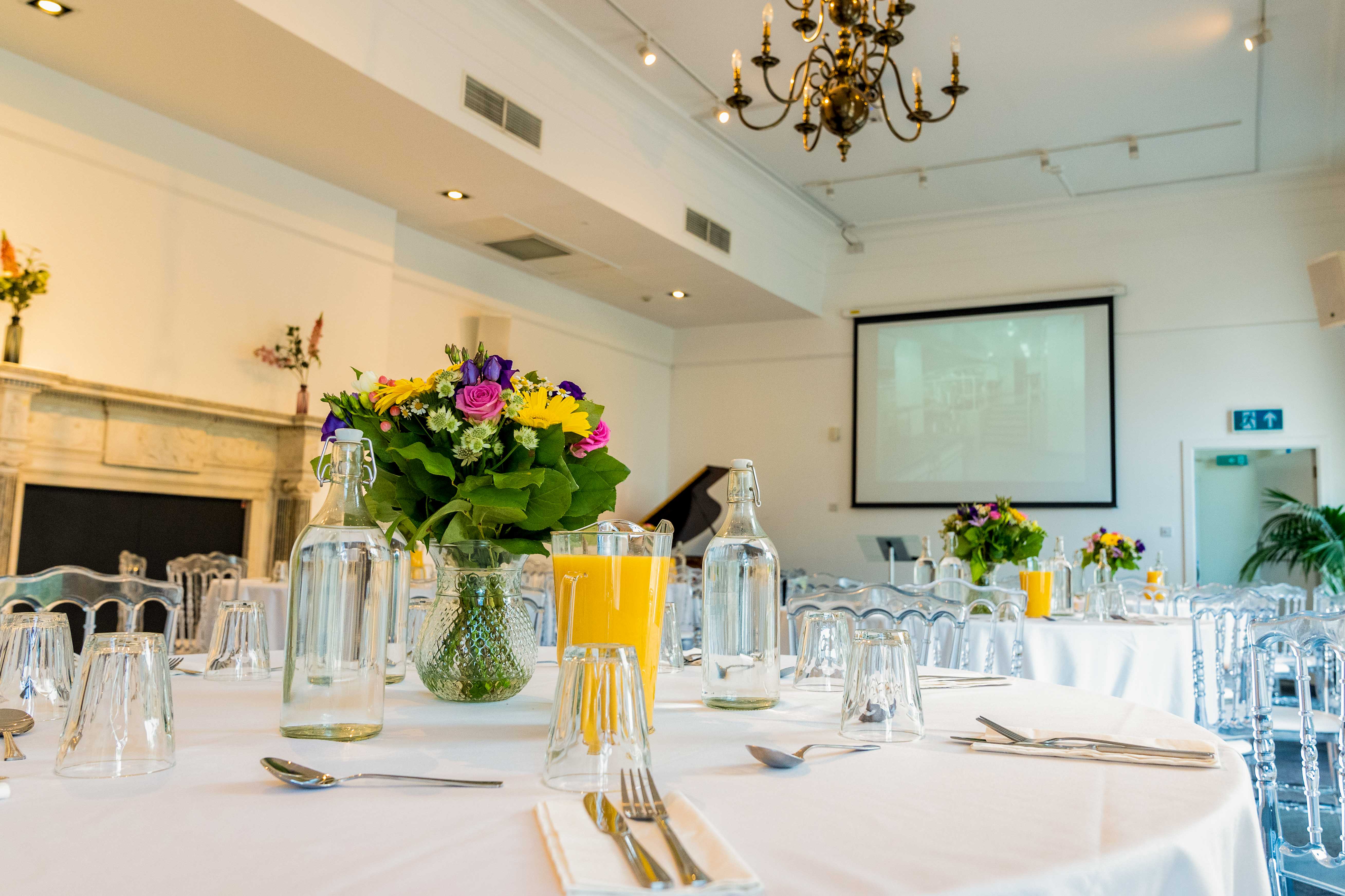 Elegant event space at The Gulbenkian with floral centerpieces for meetings and gatherings.