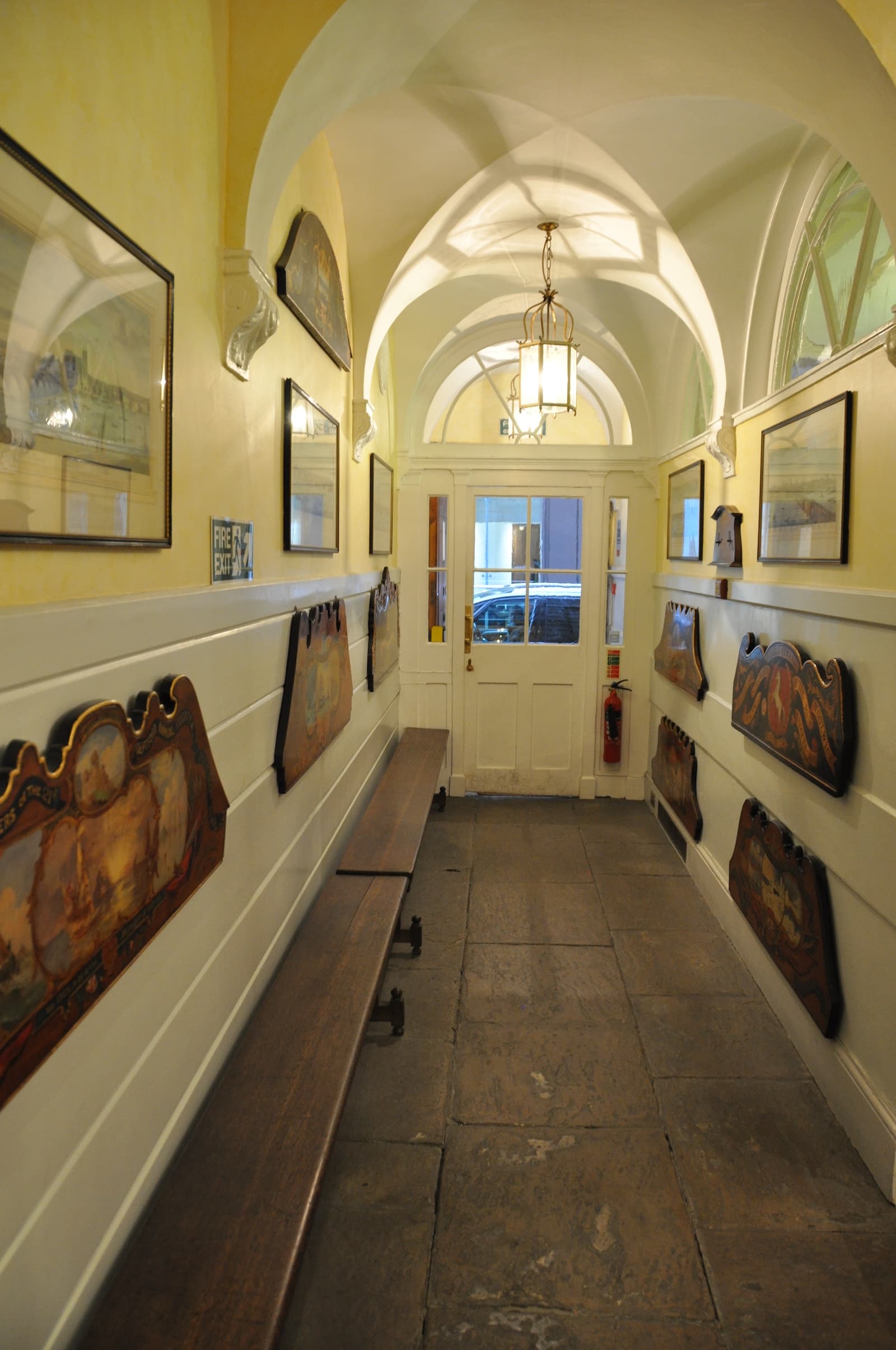Silver Room hallway with artwork and benches, ideal for events and mingling.