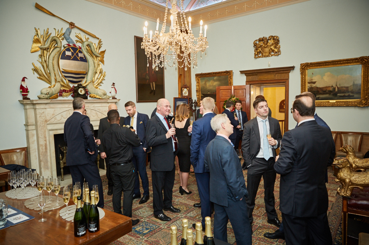 Elegant courtroom networking event with chandelier, ideal for corporate gatherings.