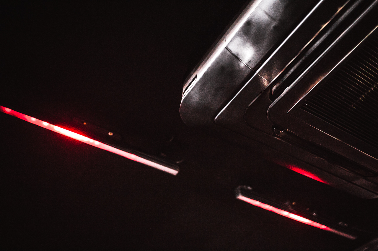 Sleek ceiling fixture with red lighting at The Blackbox, ideal for events and meetings.