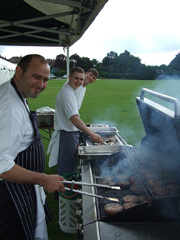 Chefs grilling outdoors at Dragon's & Lion's Suites for summer events and team-building.