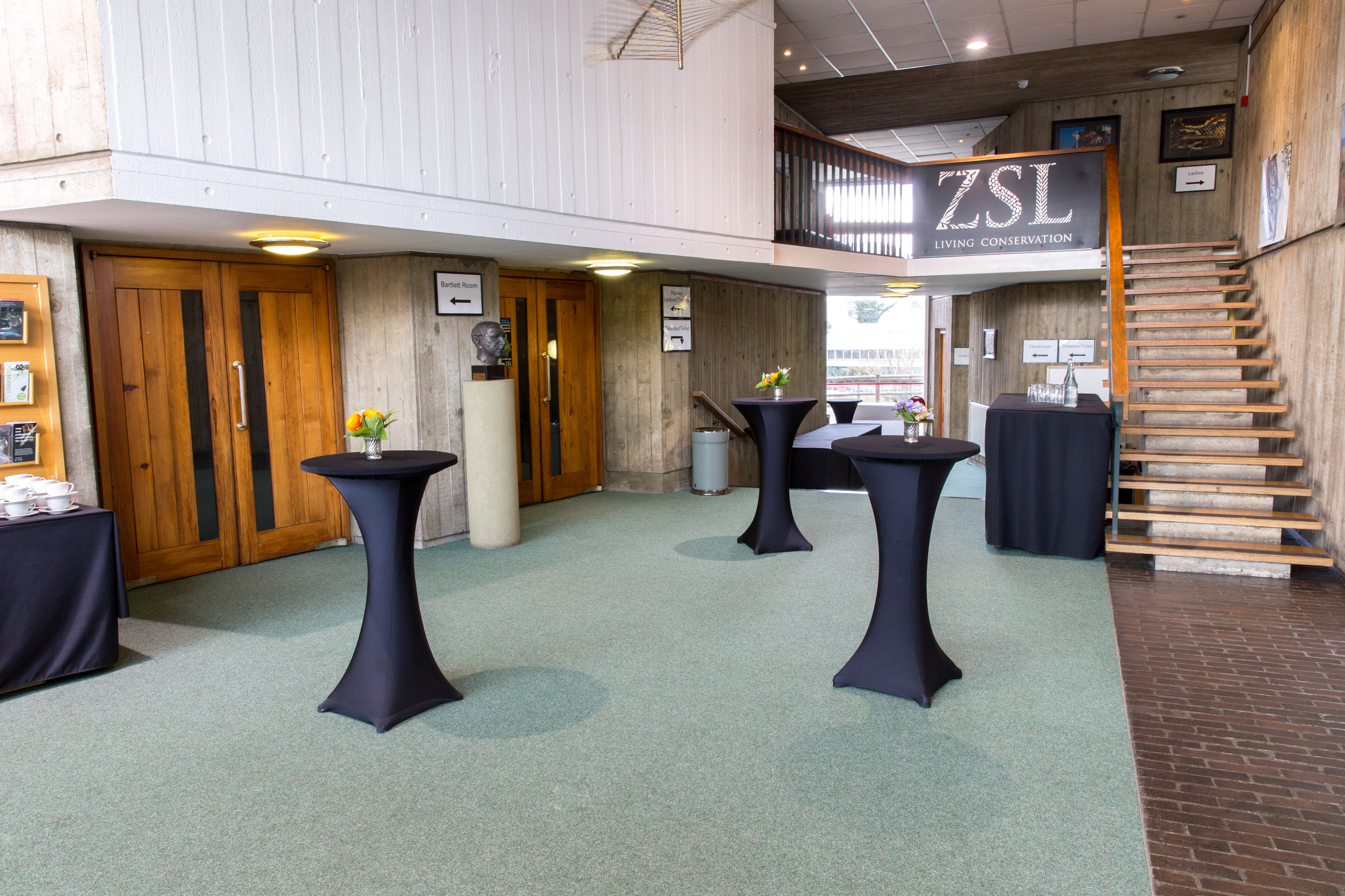 Huxley Theatre event space with sleek cocktail tables at ZSL London Zoo.