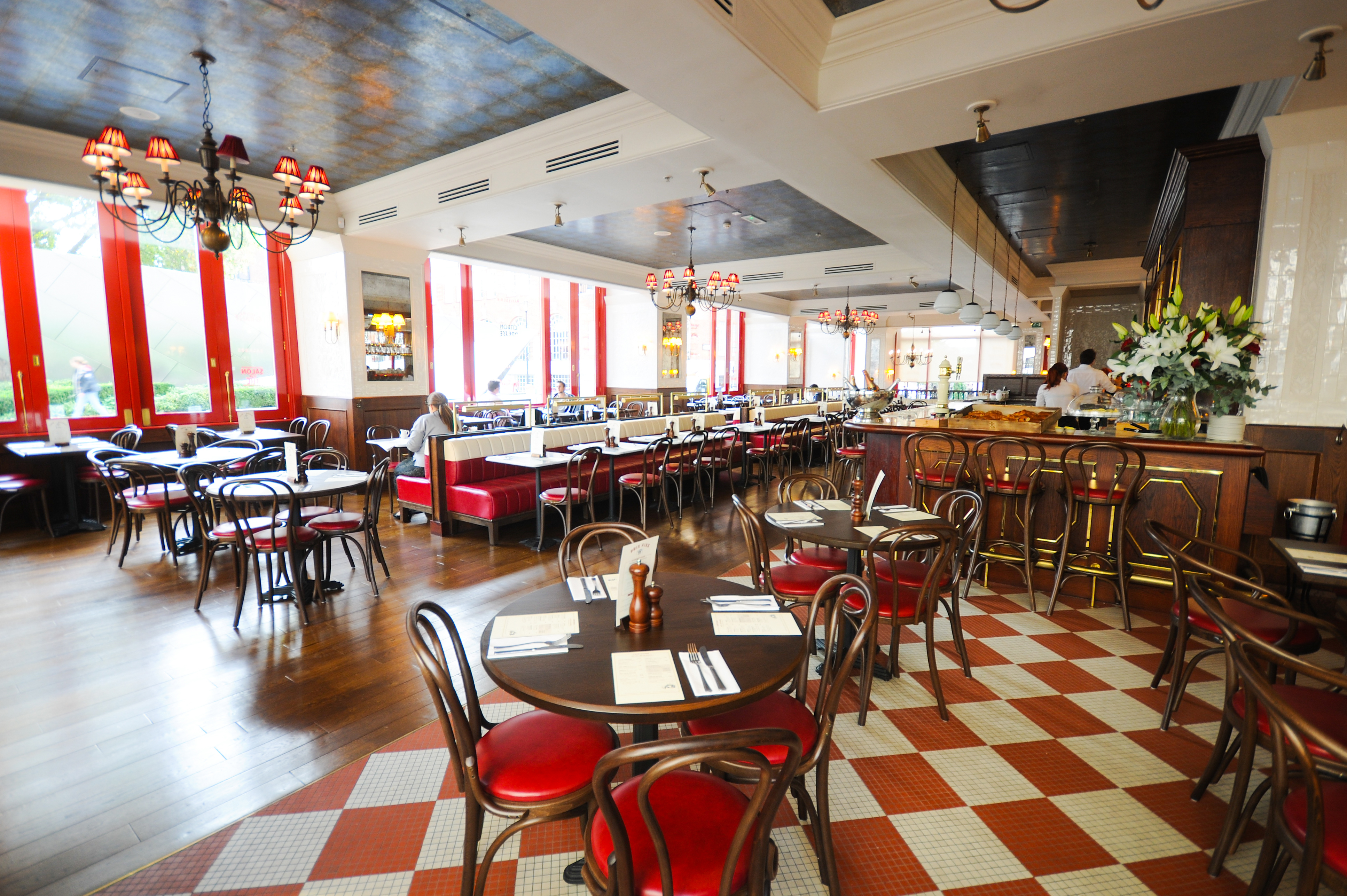 Vibrant Café Rouge St Pauls venue with round tables for intimate meetings and events.