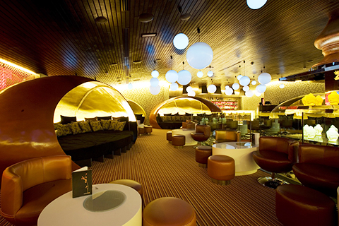 Stylish lounge at Cinnabar, featuring cozy circular booths for networking events.