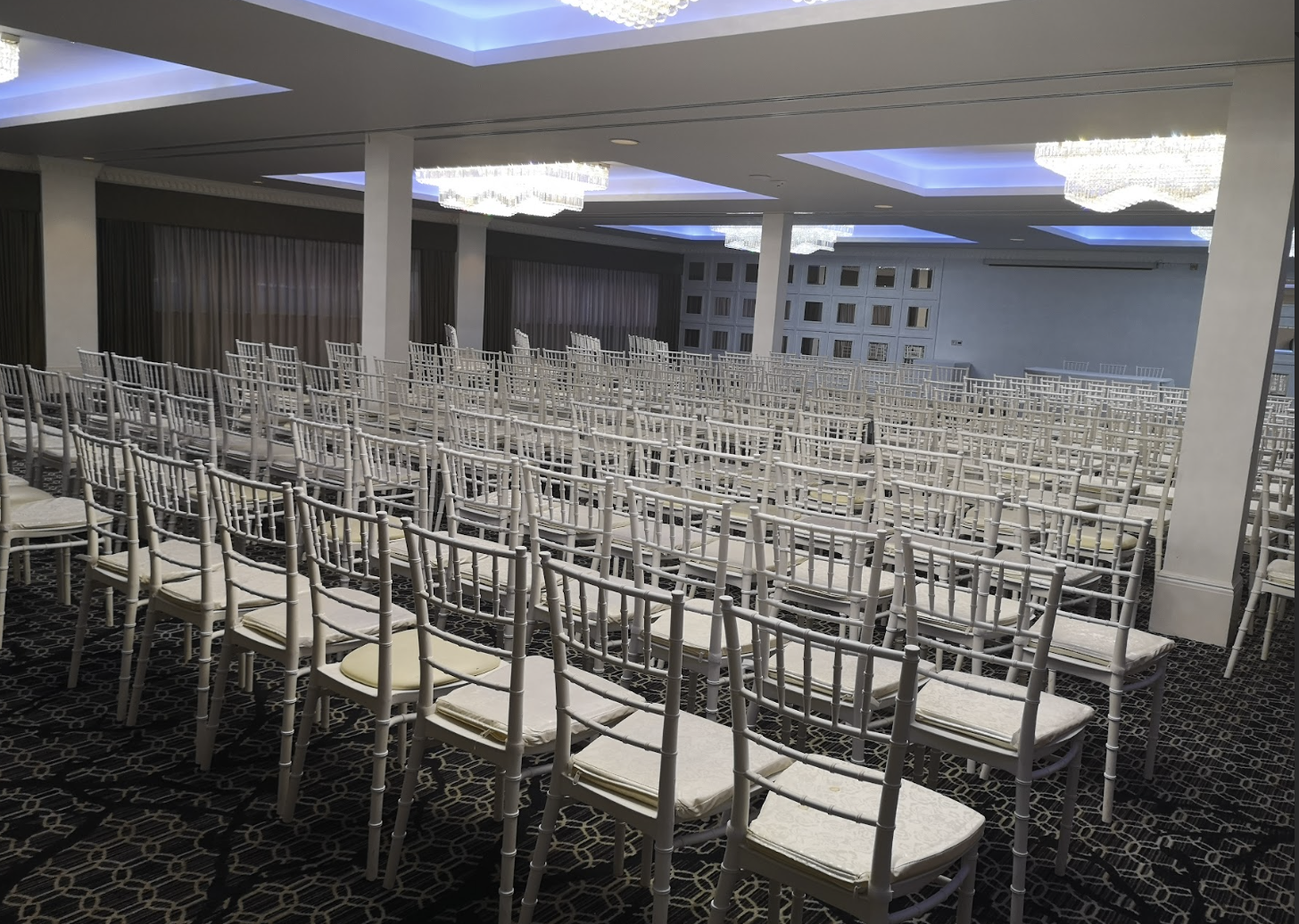 Alan Turing event space with silver chiavari chairs for formal gatherings and conferences.
