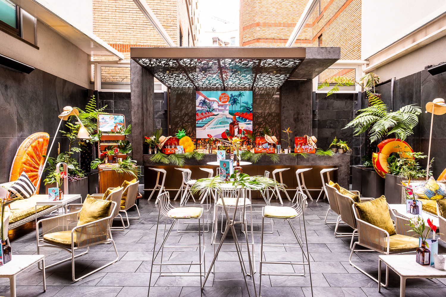 Vibrant Secret Garden event space with tropical decor for intimate gatherings and networking.