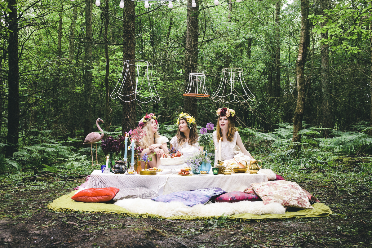 Whimsical outdoor venue in Sussex for unique events with vintage decor and lush forest backdrop.