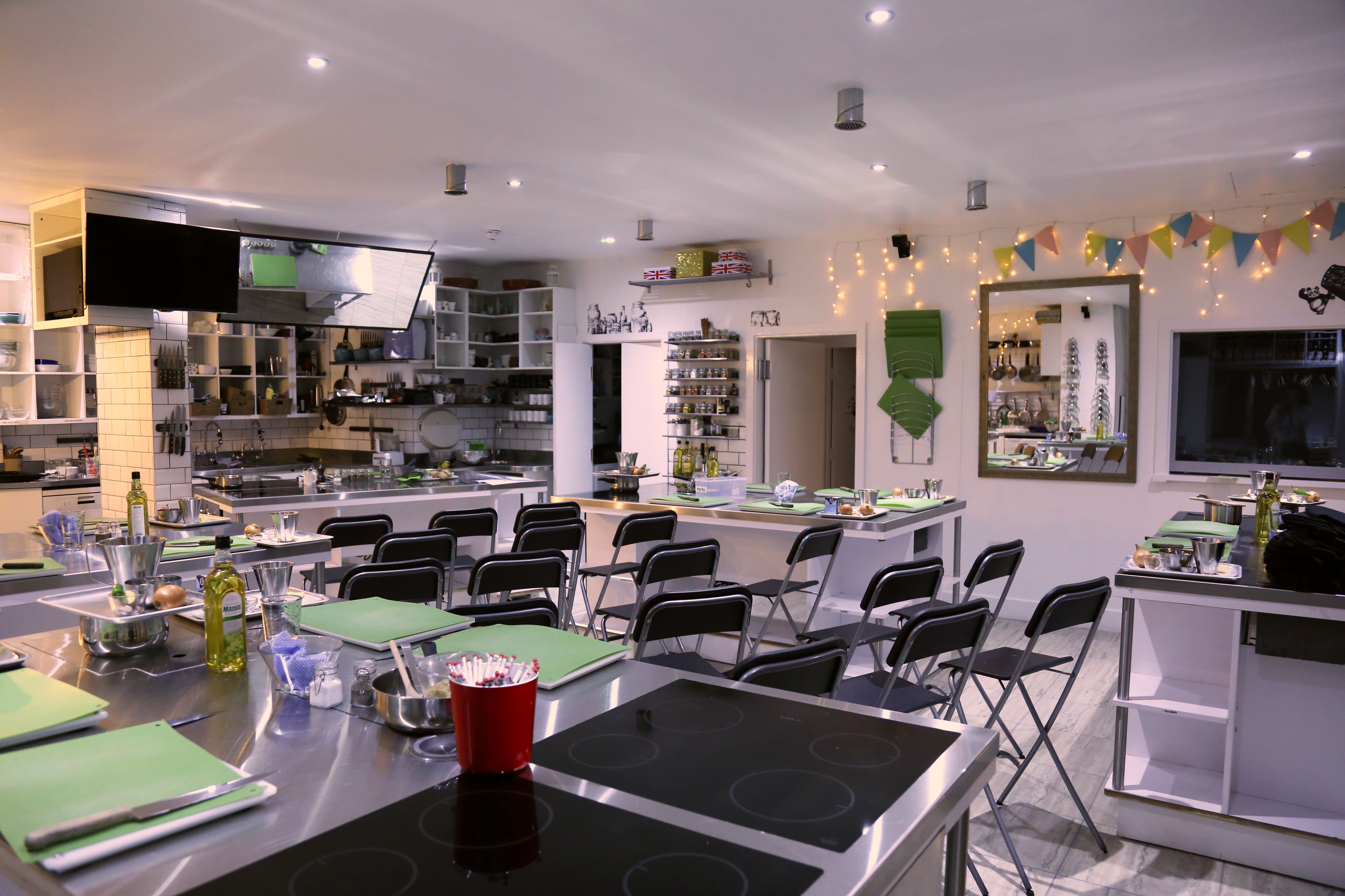 Professional kitchen for rent with stainless steel countertops, ideal for cooking classes and events.