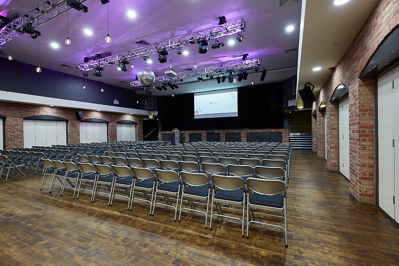 Spacious event venue with modern design, ideal for conferences and seminars.