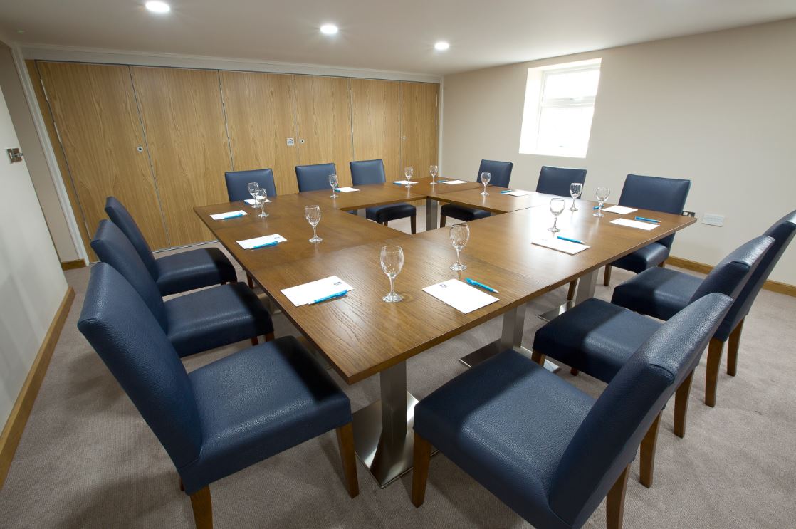 Davies Suite meeting room at Sandford Springs Hotel, modern setup for events.