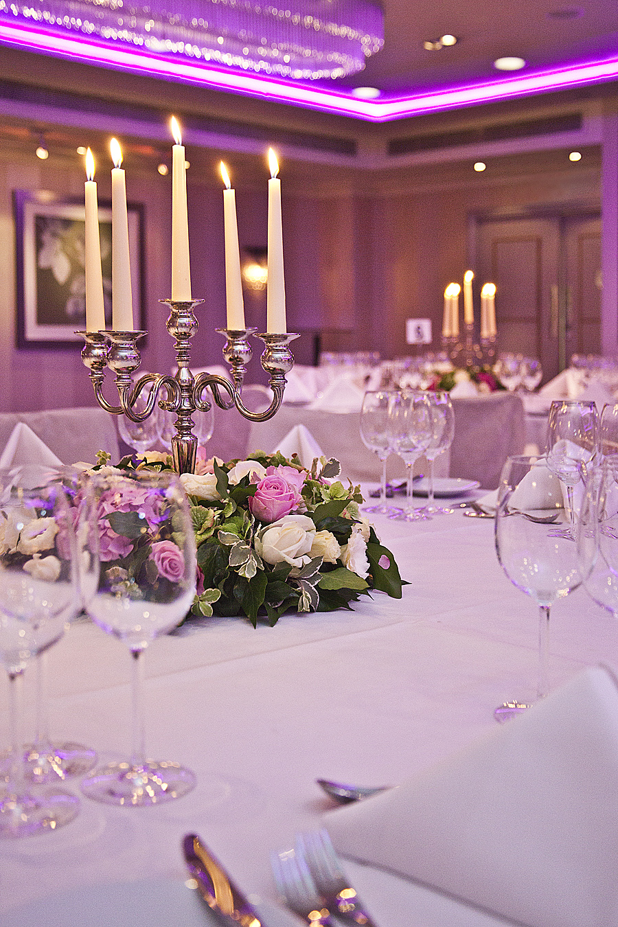 Elegant dining table with roses in Mayfair Suite, perfect for weddings and formal events.