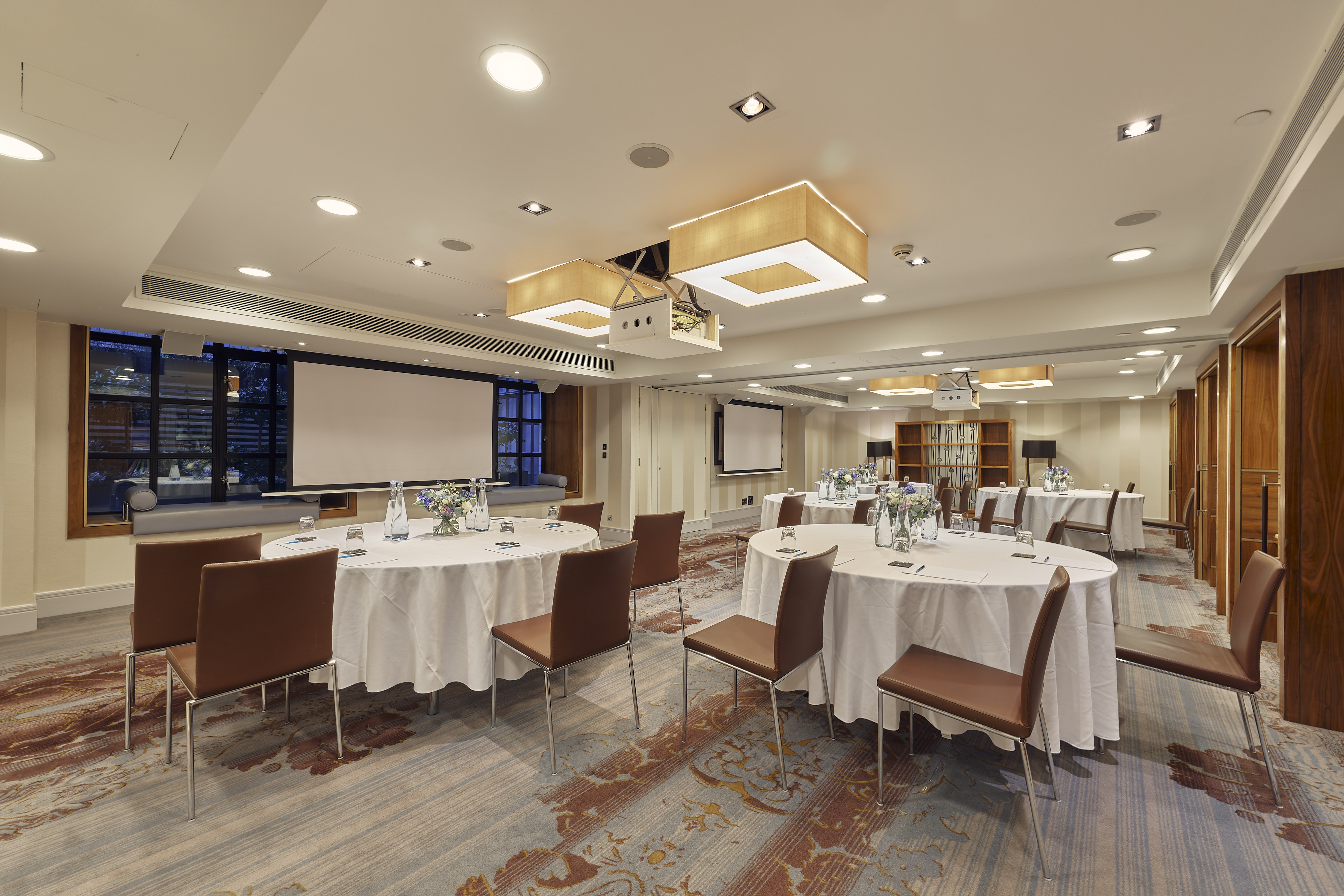 Corporate meeting room at Sofitel London St James with round tables and natural light.