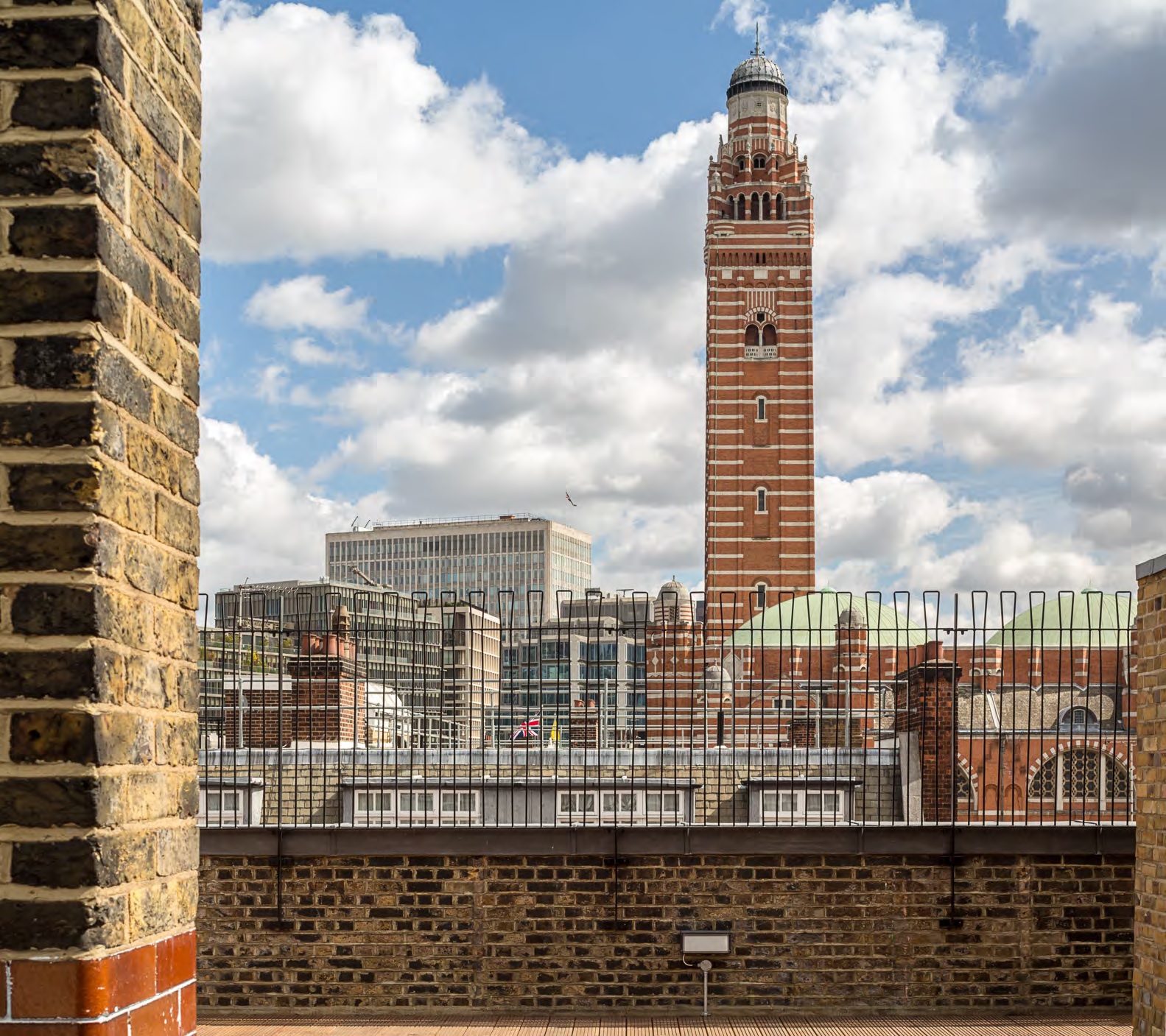 Rooftop garden with clock tower skyline, perfect for urban events and gatherings.