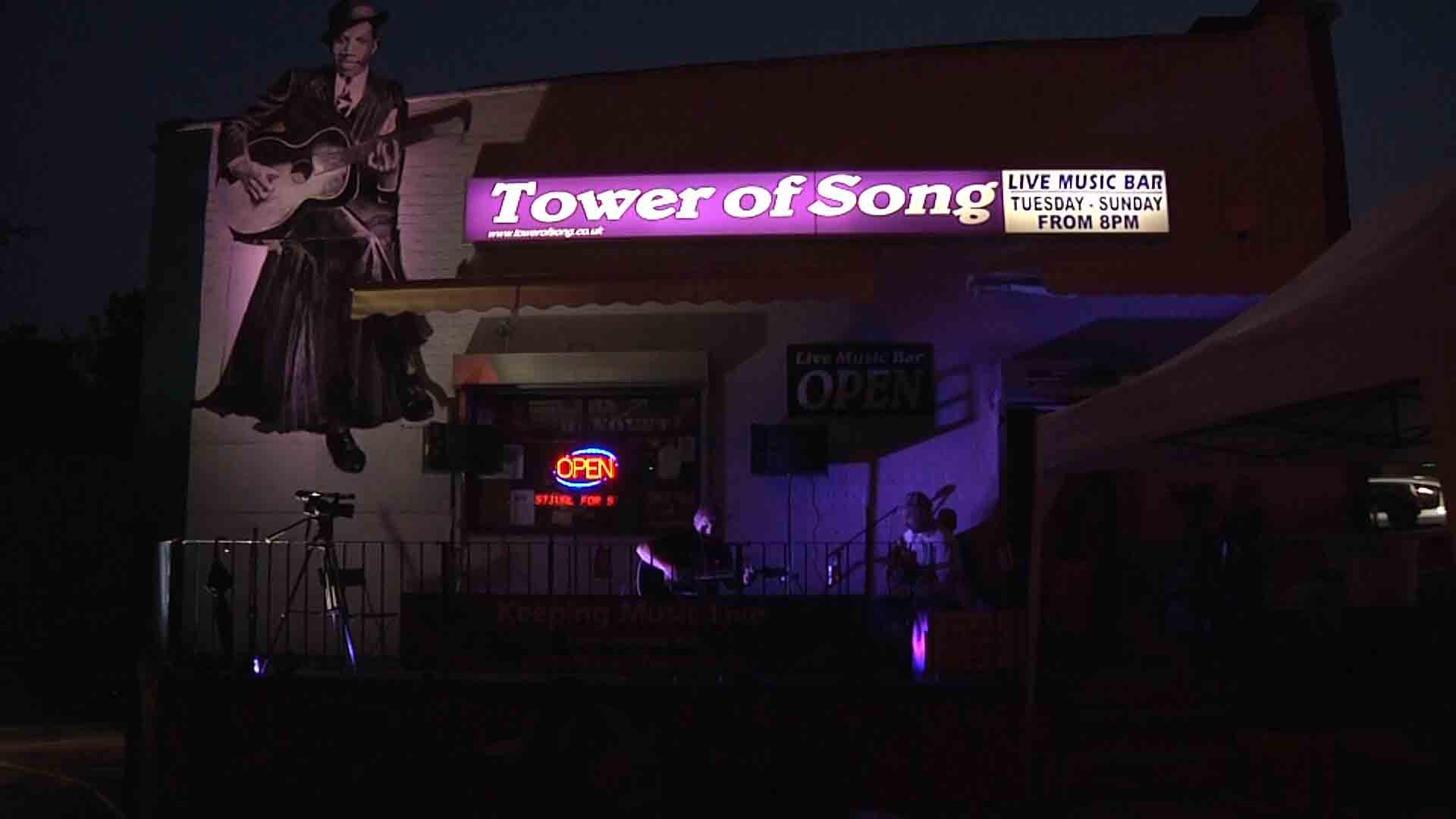 Vibrant Tower of Song venue with illuminated signage for live music events.