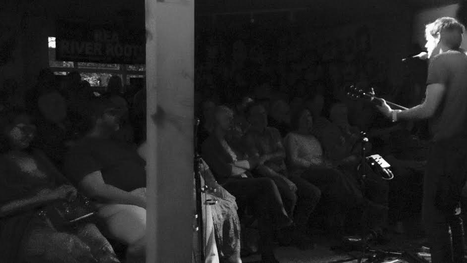 Intimate live performance at The Tower of Song with cozy lighting for acoustic events.