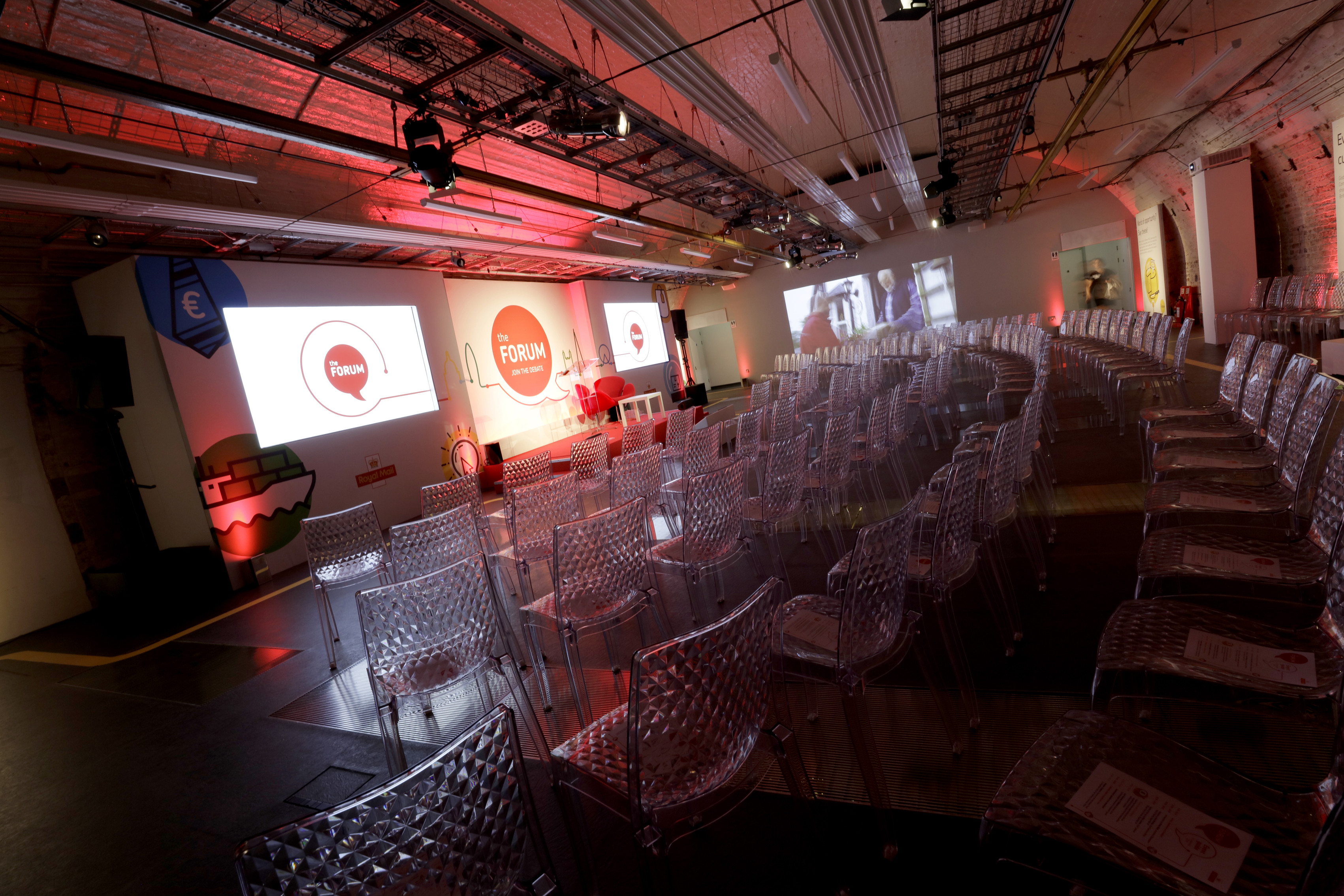 Mail Rail event space with transparent chairs, ideal for conferences and panel discussions.