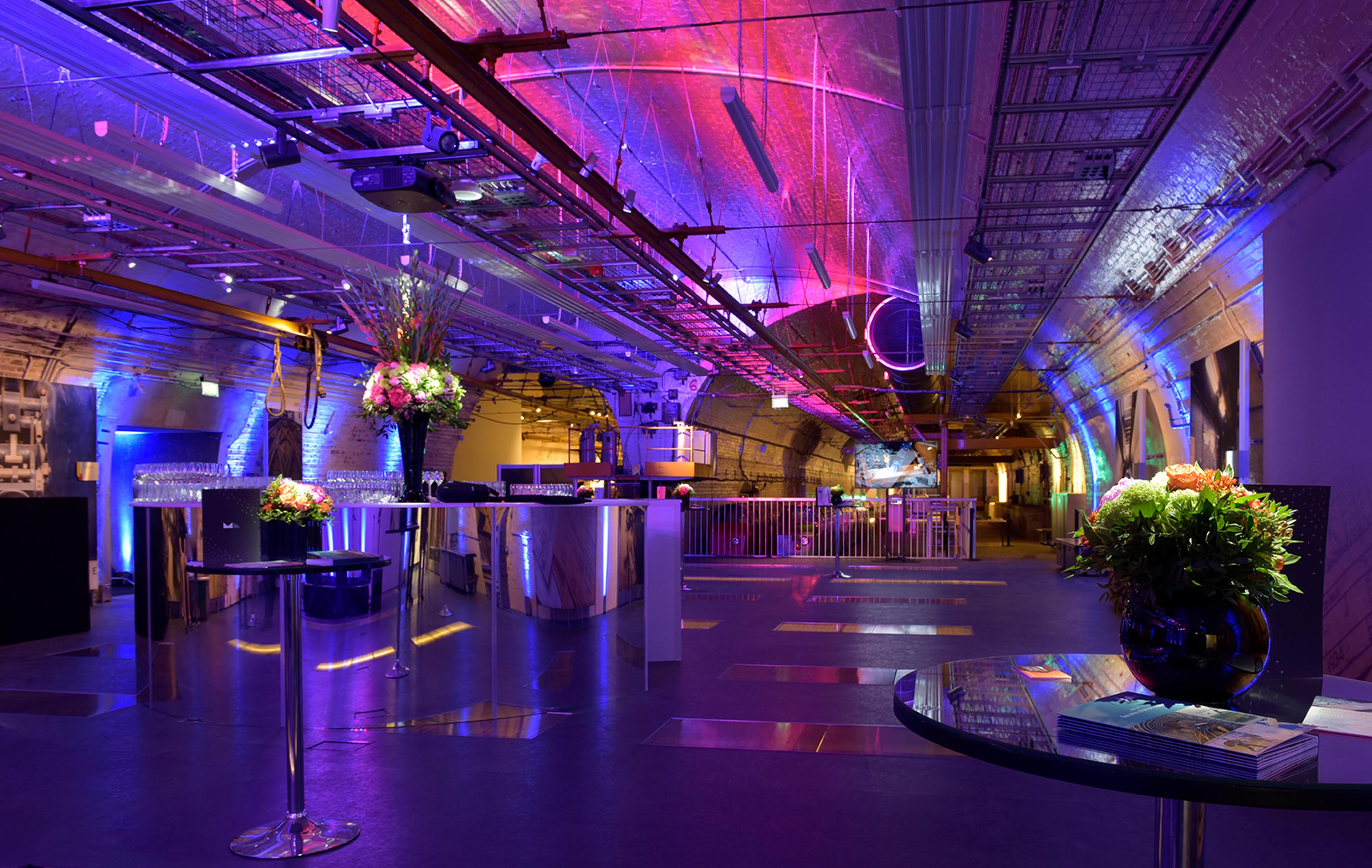 Mail Rail event space in The Postal Museum with vibrant lighting for upscale gatherings.